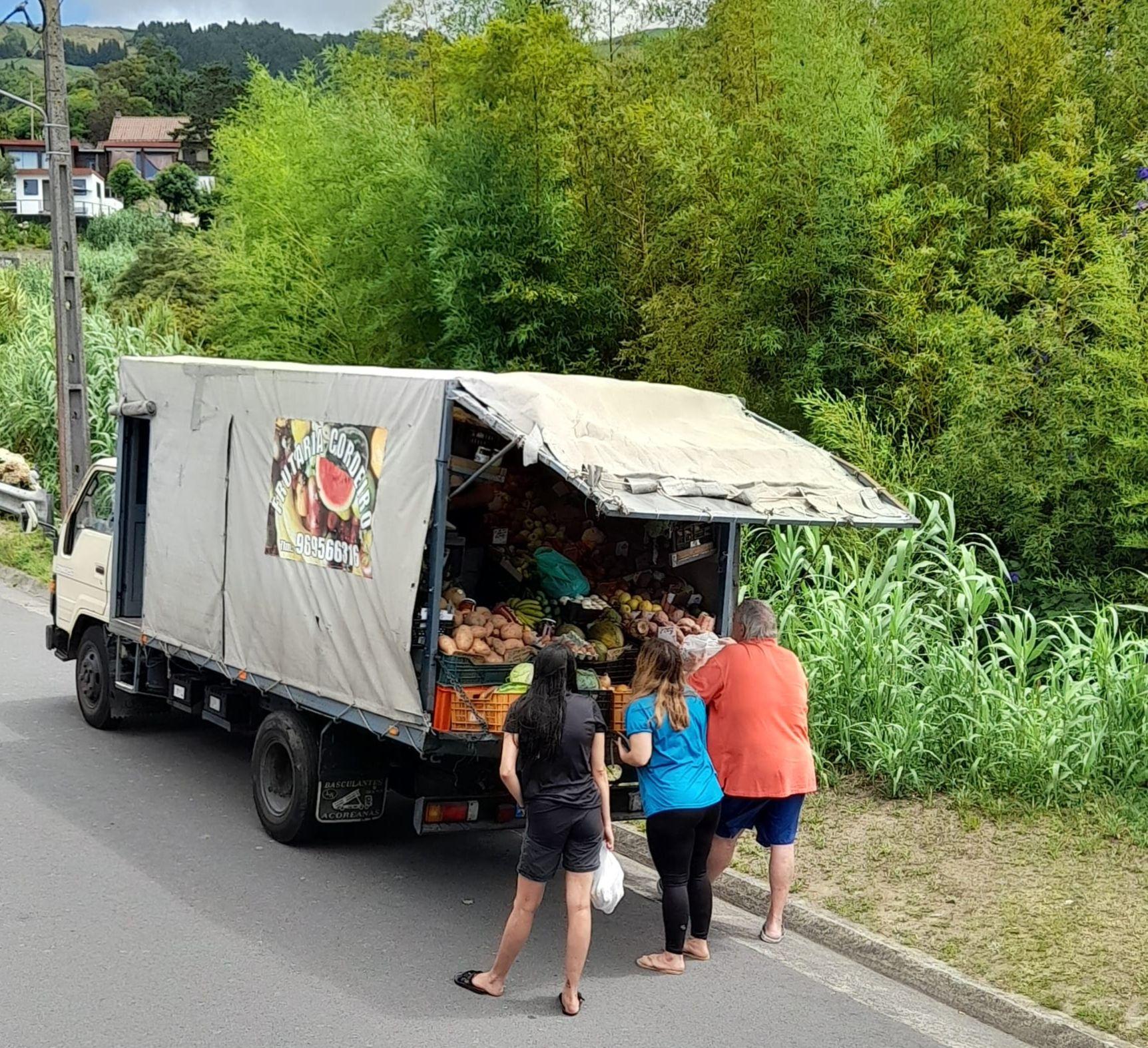 Guests shopping at a local mobile vegetable vendor truck on the street near Novovento