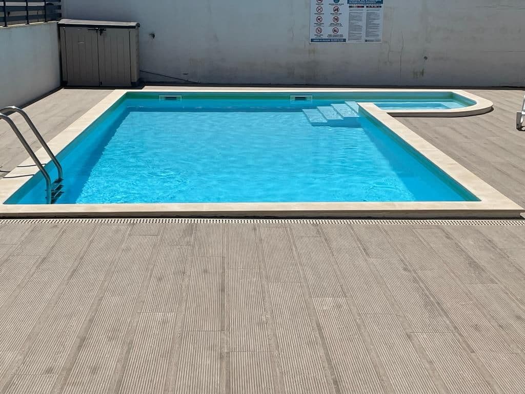Outdoor swimming pool with blue water on the terrace