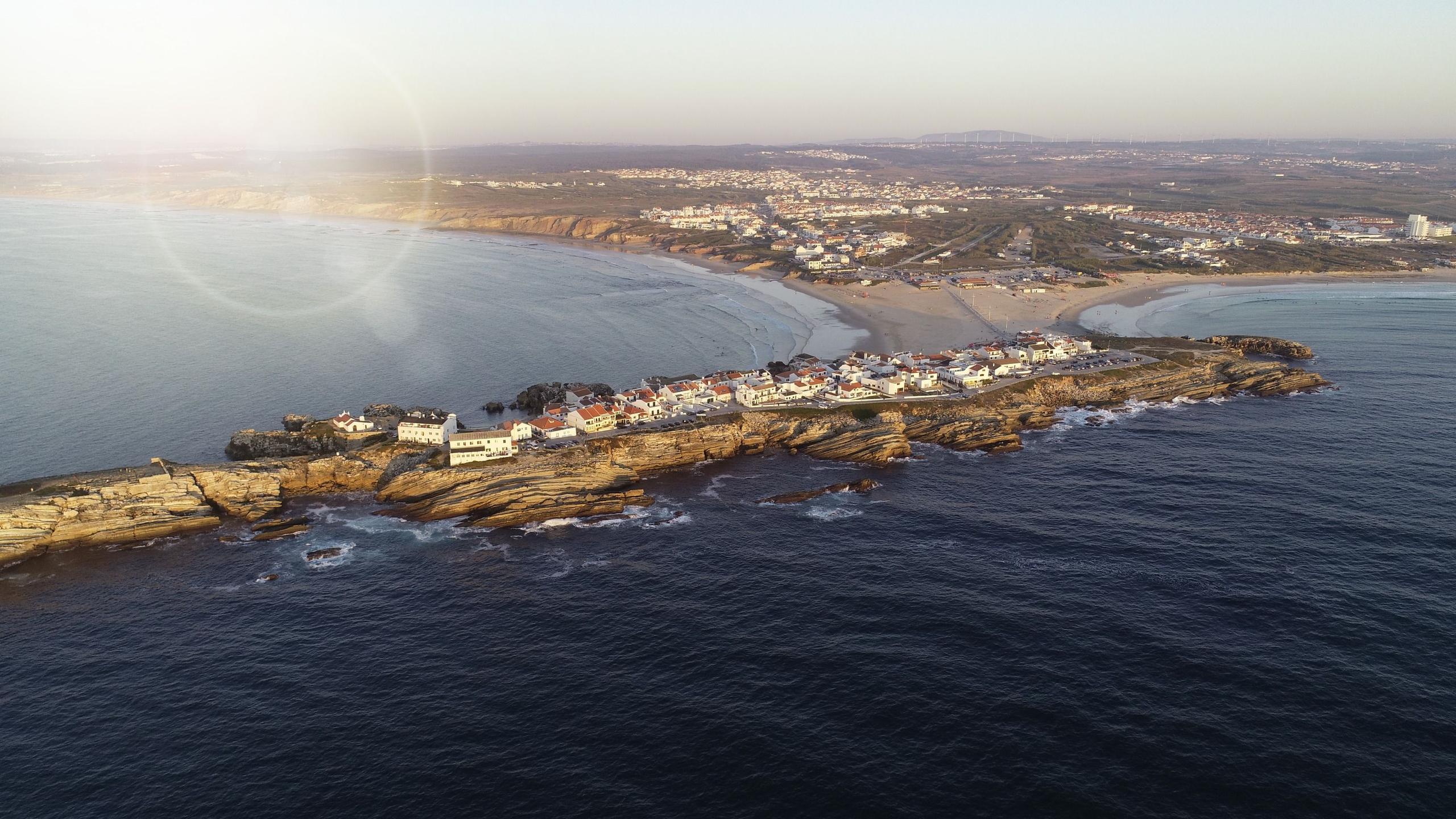 Aerial drone shot of the Baleal peninsula and surrounding coastline at sunset