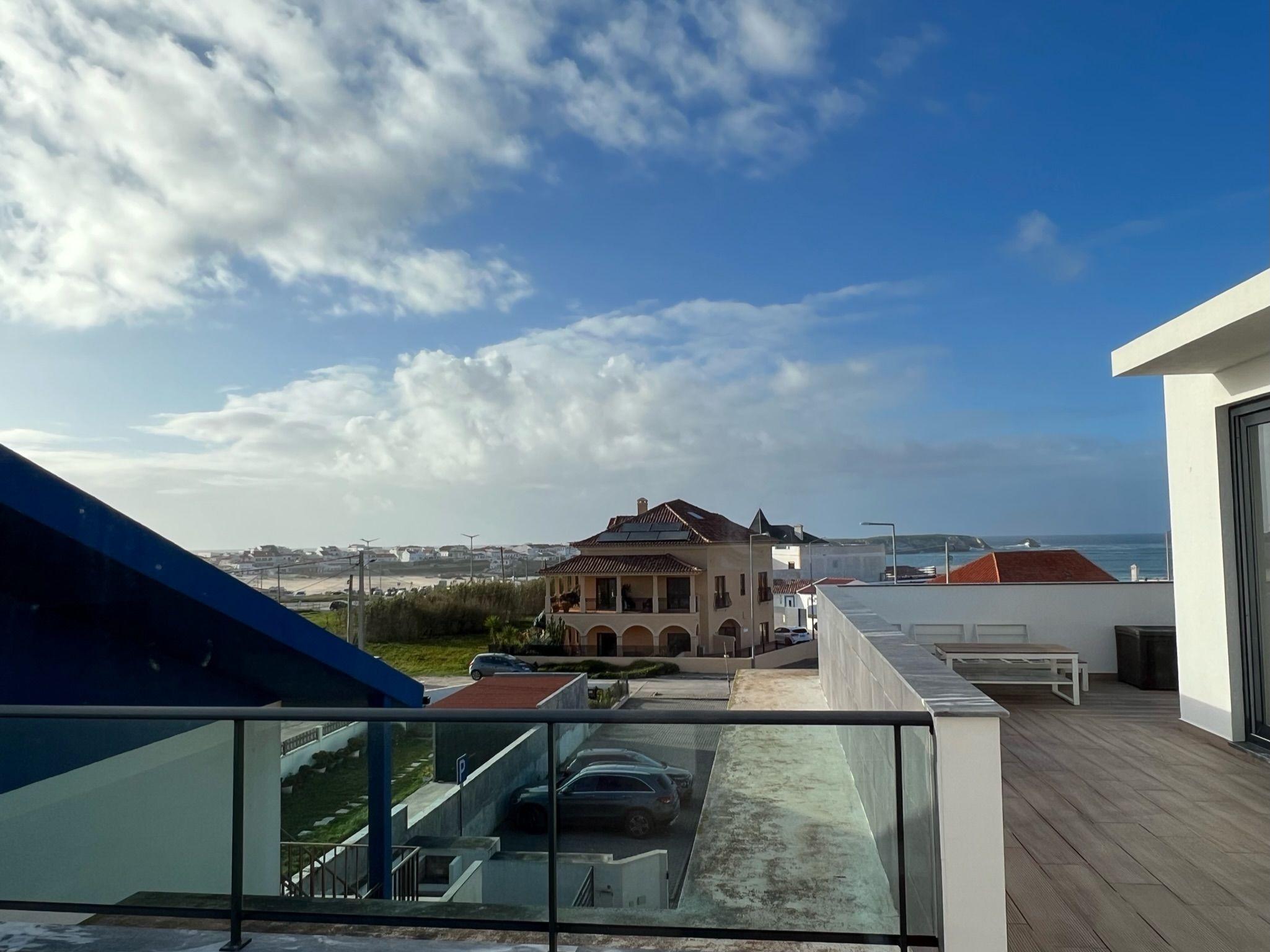 View from the Ensuíte Cantinho room showing the wrap-around terrace and ocean/beach view