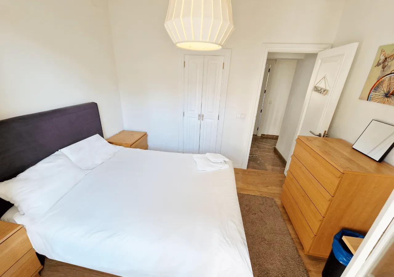 Spacious private double bedroom Estrella with a double bed, dresser, and wardrobe