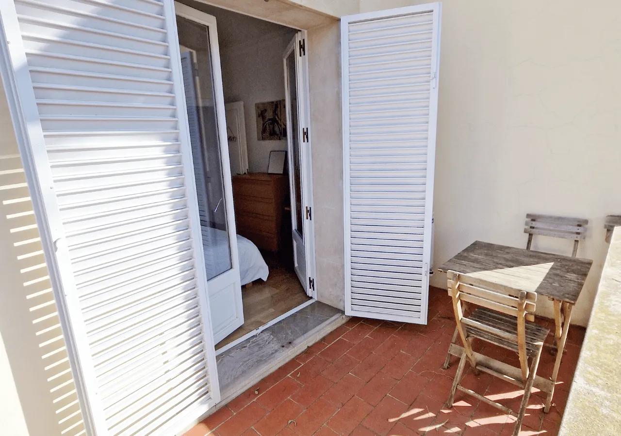Private balcony of the Estrella bedroom with outdoor chairs and a small table