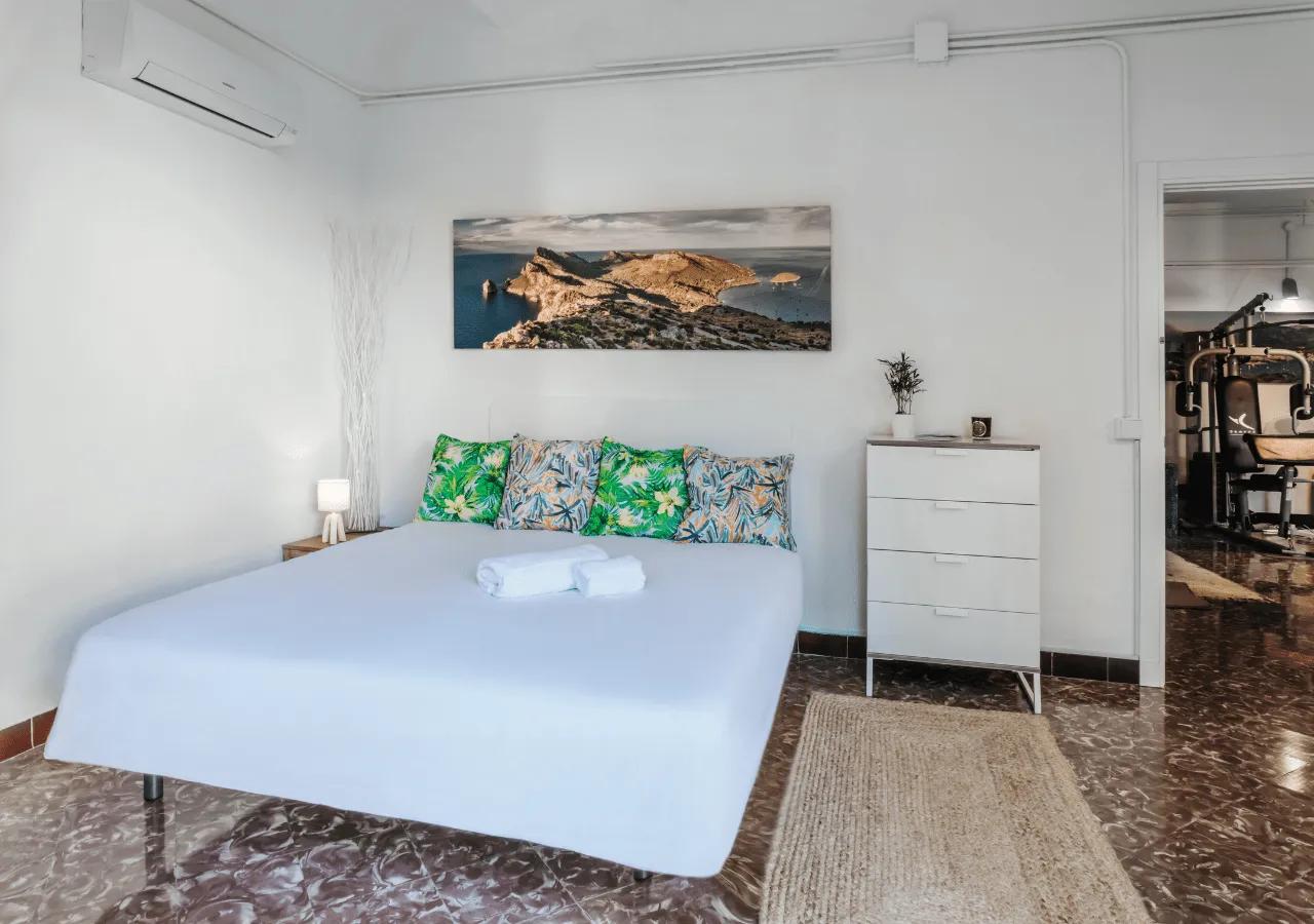 Double bedroom Oasis with a large double bed, tropical decor, AC unit, and direct access to the garden area