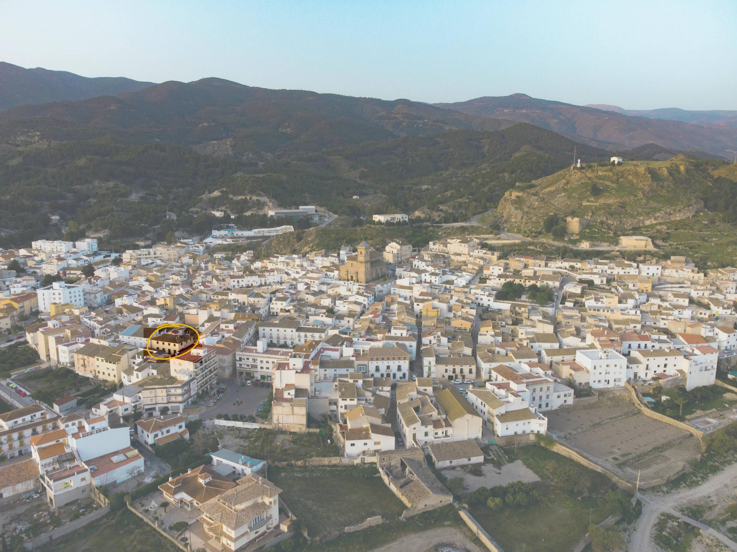 Aerial drone view of the village of Purchena in southeastern Spain, with the Picassa coliving house highlighted in the centre, surrounded by mountains