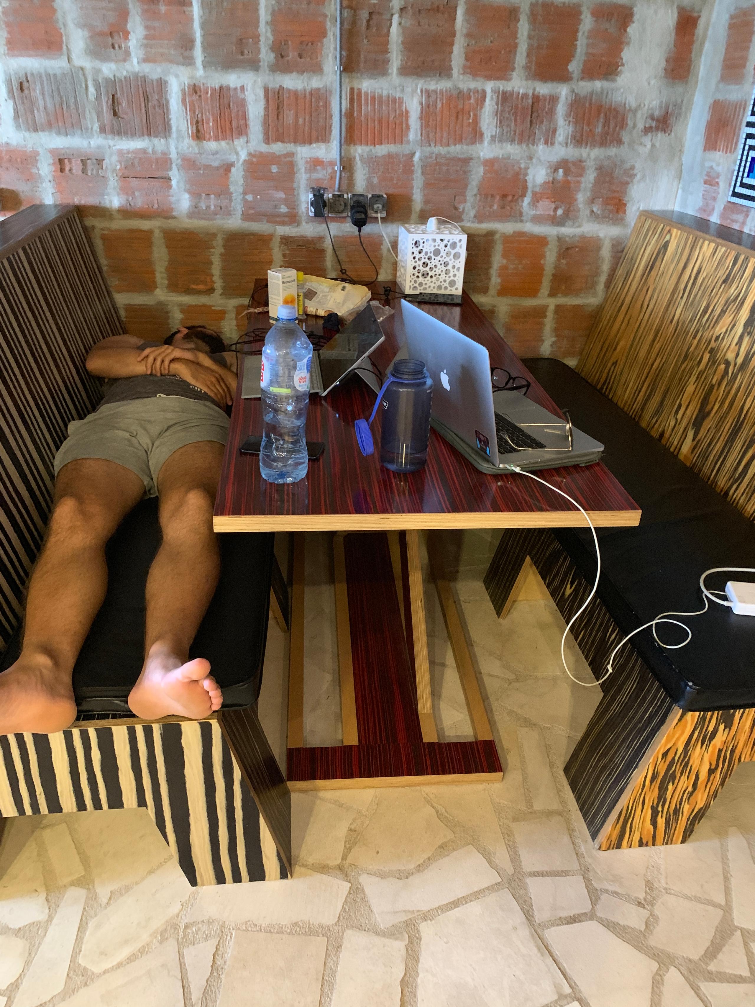 Person working on a laptop at a desk in the coworking space