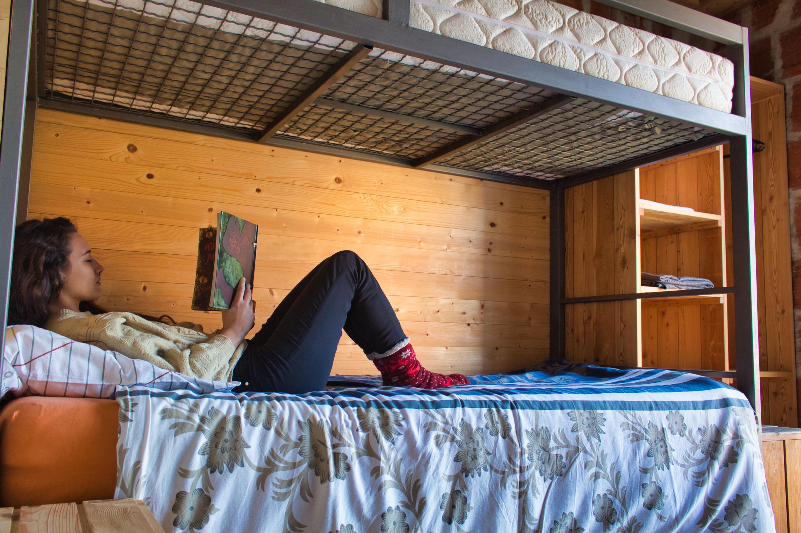 Standard private room showing the lower bunk bed with wooden shelving