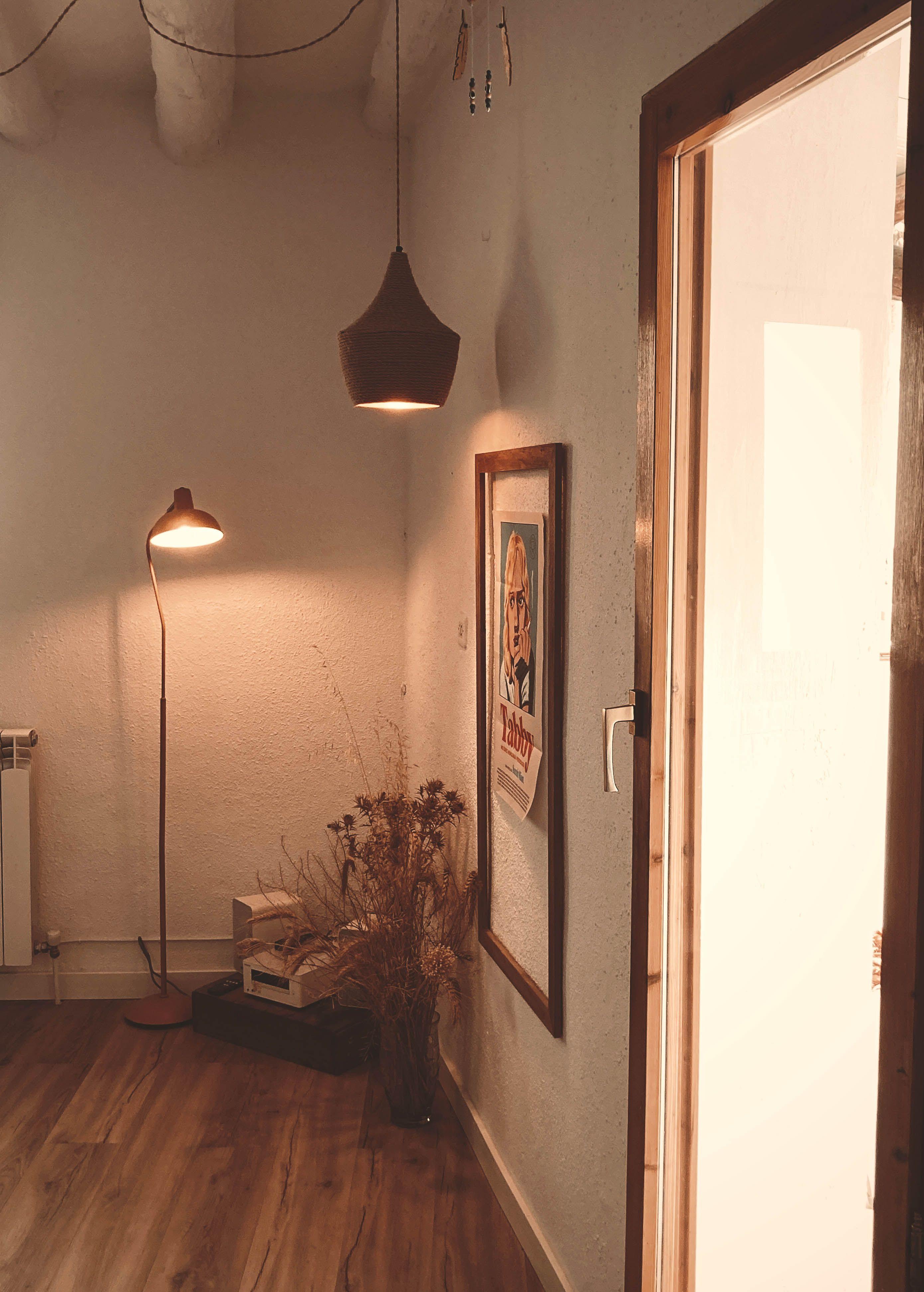 Relaxation lounge at Posada de la Luz showing a lit floor lamp, music system, framed print and hanging ceiling lamp
