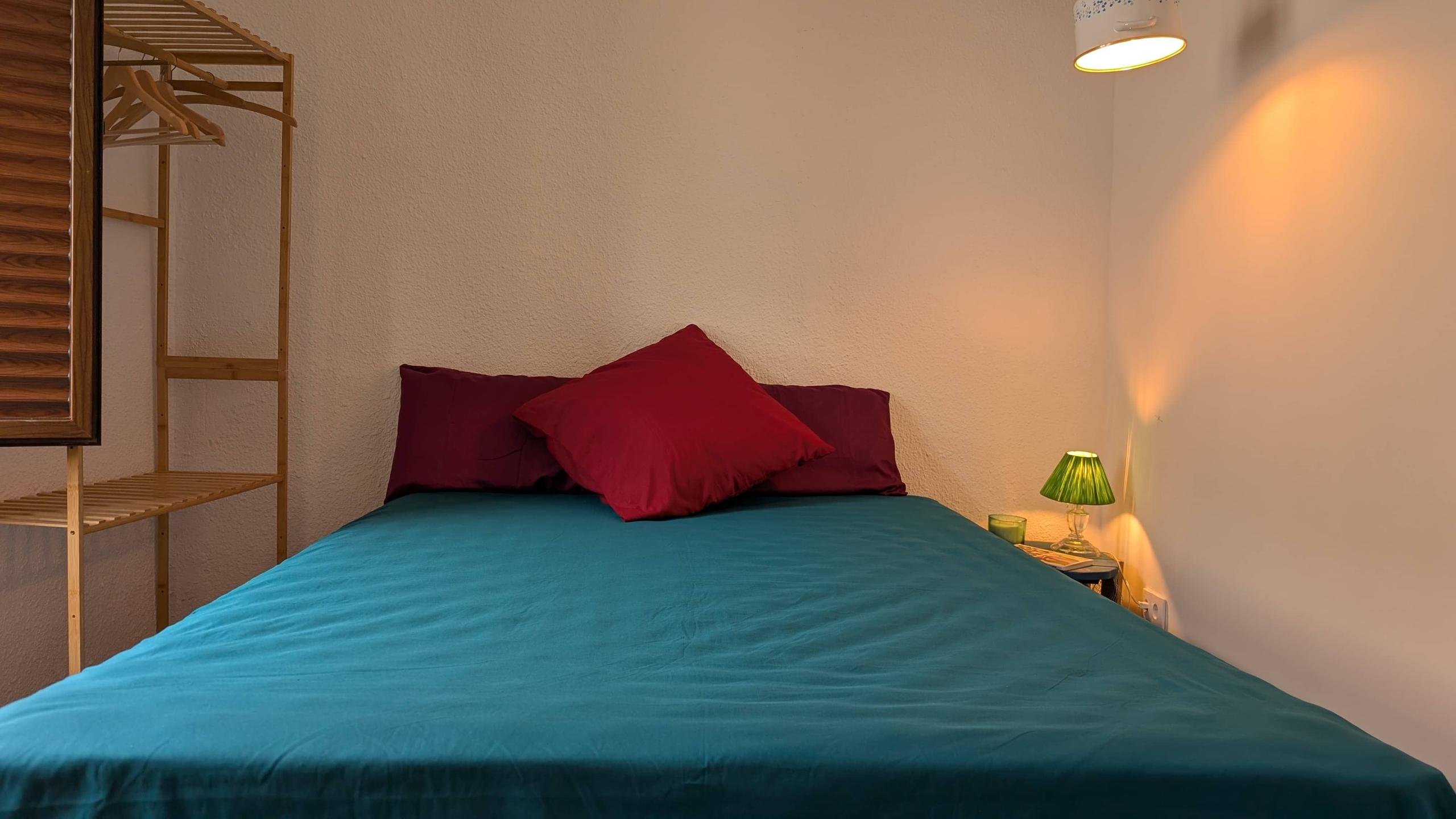 The Goldin room showing a bed and nightstand with a lamp