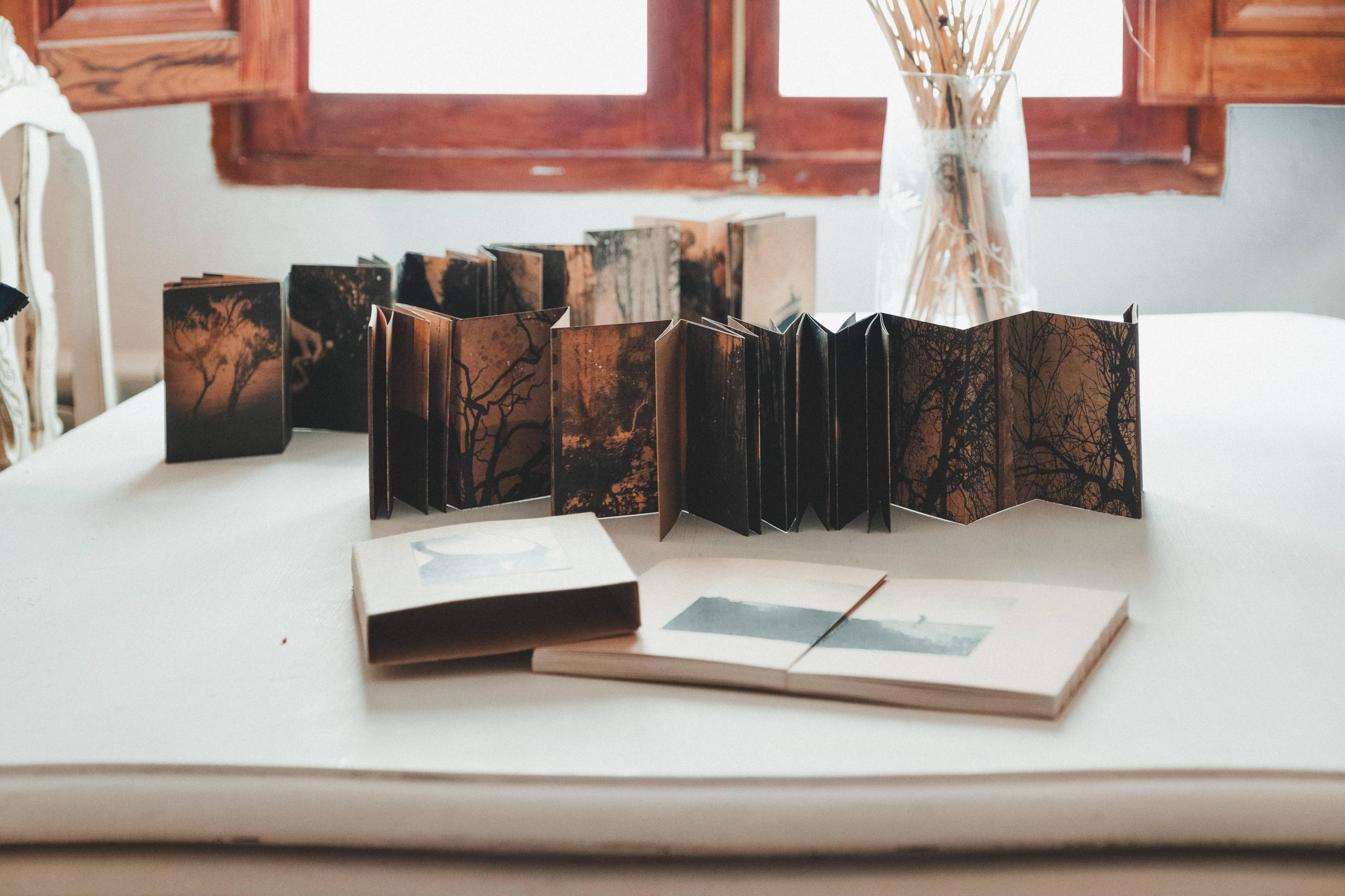 Table with open books by Juanan Requena at Posada de la Luz