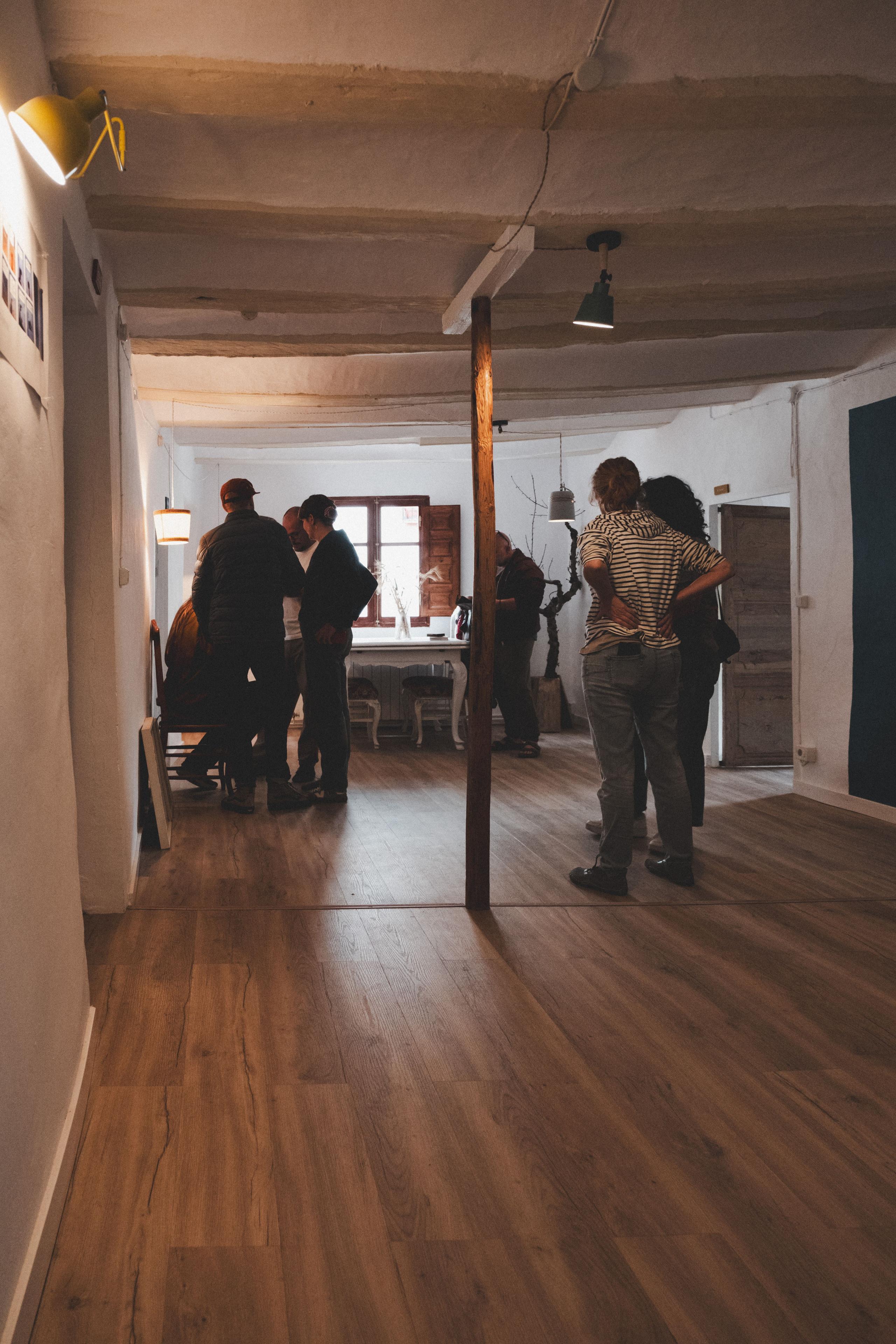 Group of people at Posada de la Luz inside an interior space, discussing a social event