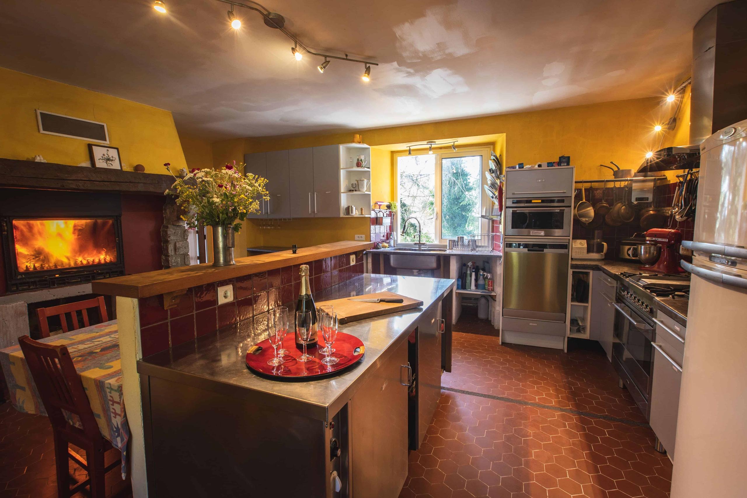 Over-equipped semi-professional shared kitchen with fireplace at Pyren'Escape