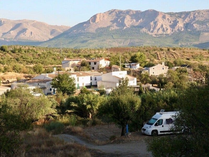Camper van parked at the Green SPOT with a panoramic view of the village and Sierra María mountains