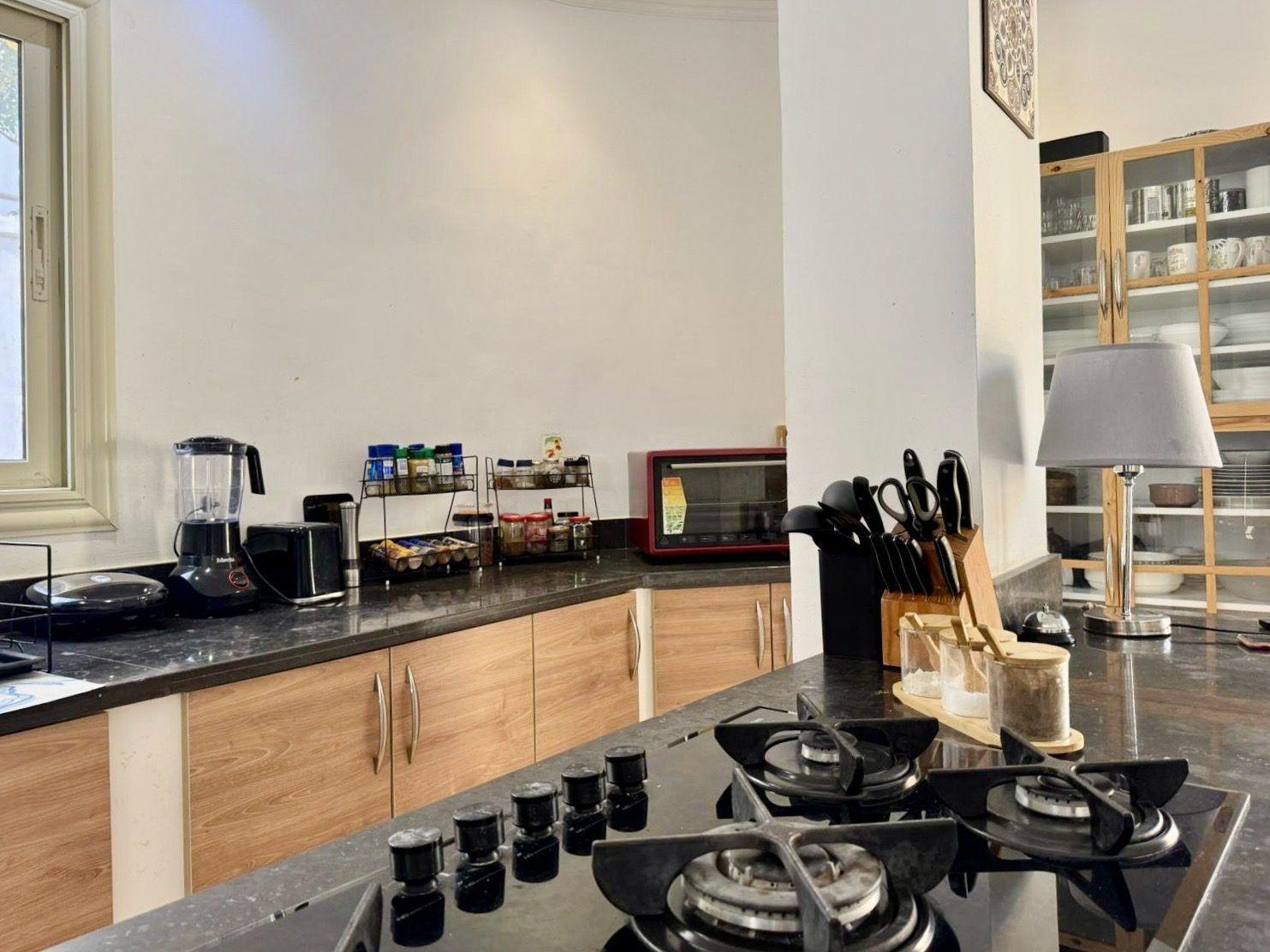Kitchen counter with appliances including blender, toaster oven, and knife block