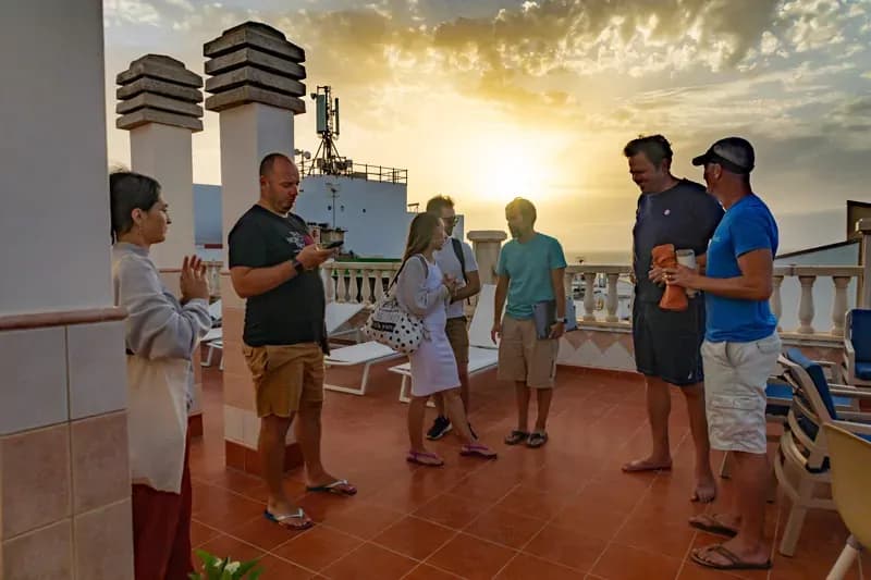Guests gathered on rooftop terrace at sunset