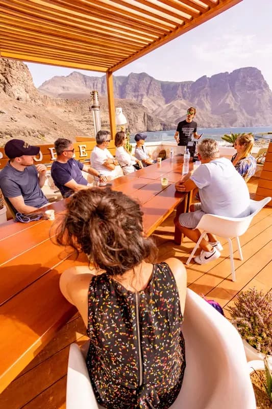 Guests gathered around a table on the rooftop terrace with mountain views
