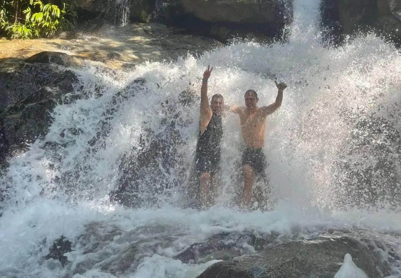 Two guests at a waterfall on the Arenales River in San Rafael, Colombia