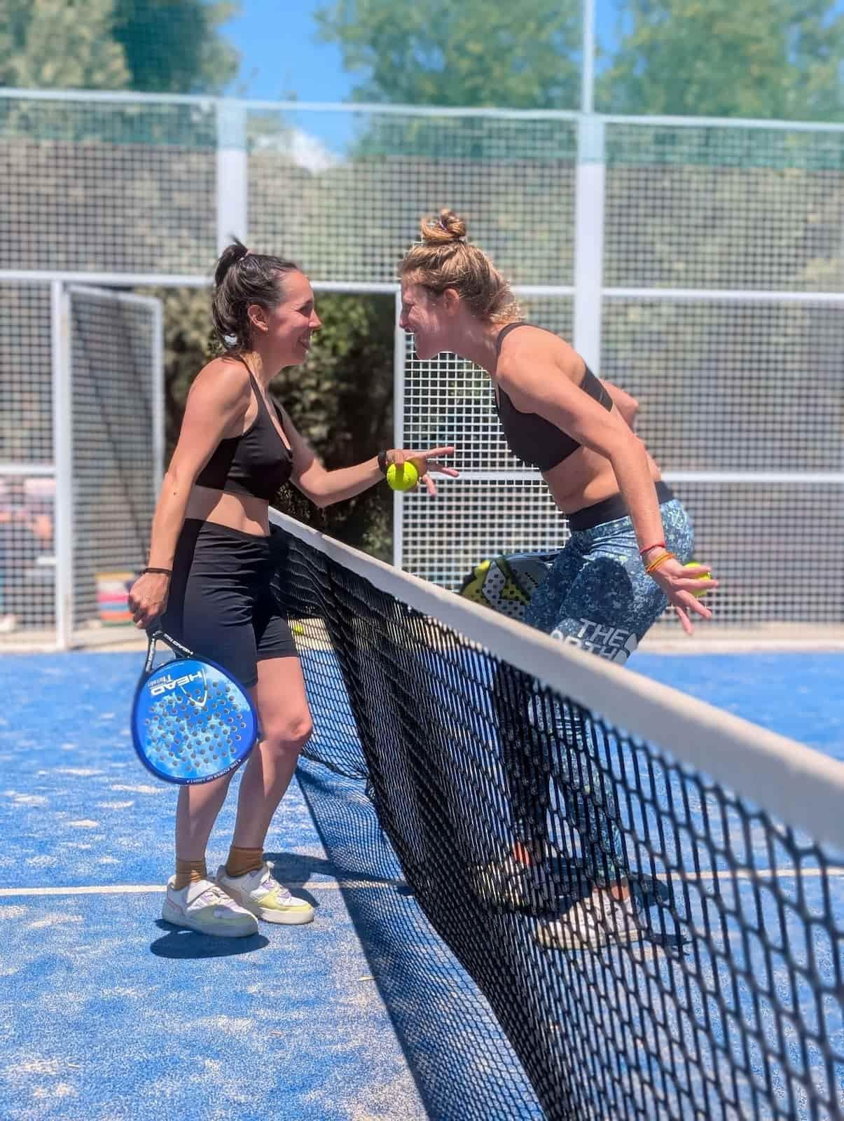 Two women playing padel tennis at Rooral coliving in rural Spain, promoting wellbeing and community living