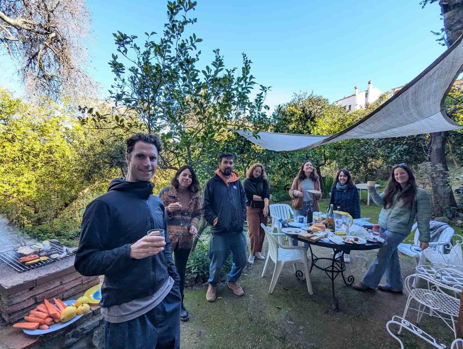 Group of colivers enjoying a BBQ gathering in the garden of a Rooral coliving home