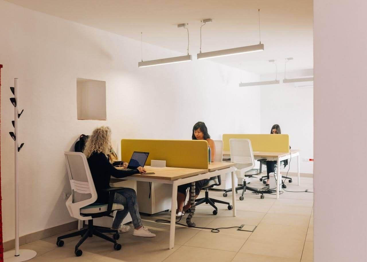 Remote workers coworking indoors together at Rooral rural coliving space in Spain