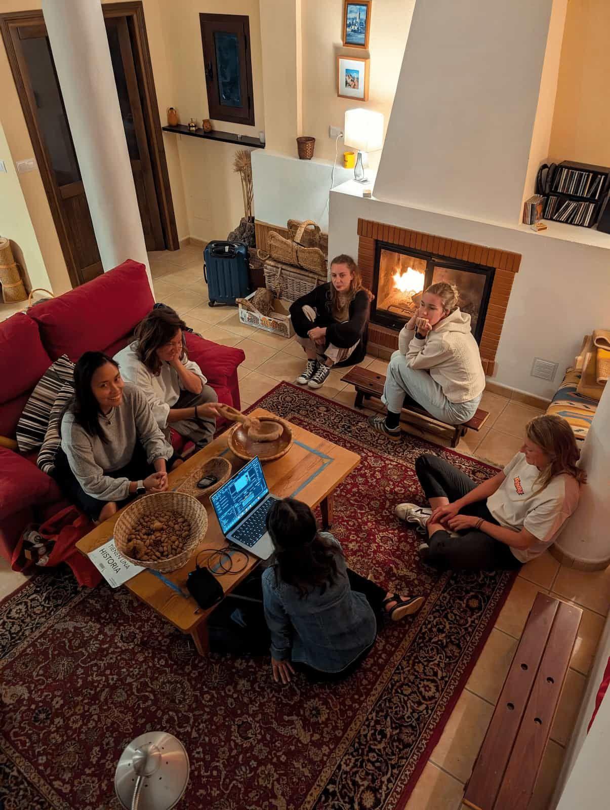 Rooral coliving residents relaxing by the fireplace in living room, ideal for remote workers and community living