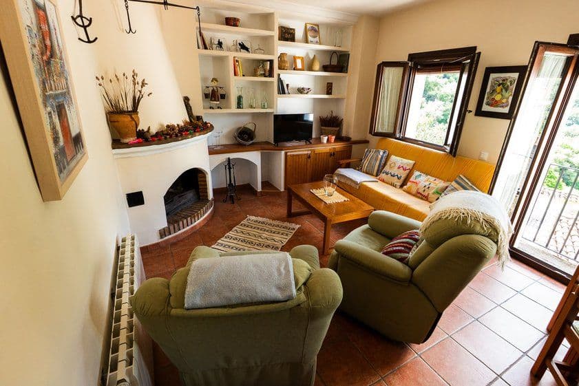 Cozy living room with fireplace, window, and stylish design at Rooral coliving, ideal for digital nomads, remote workers, and community living