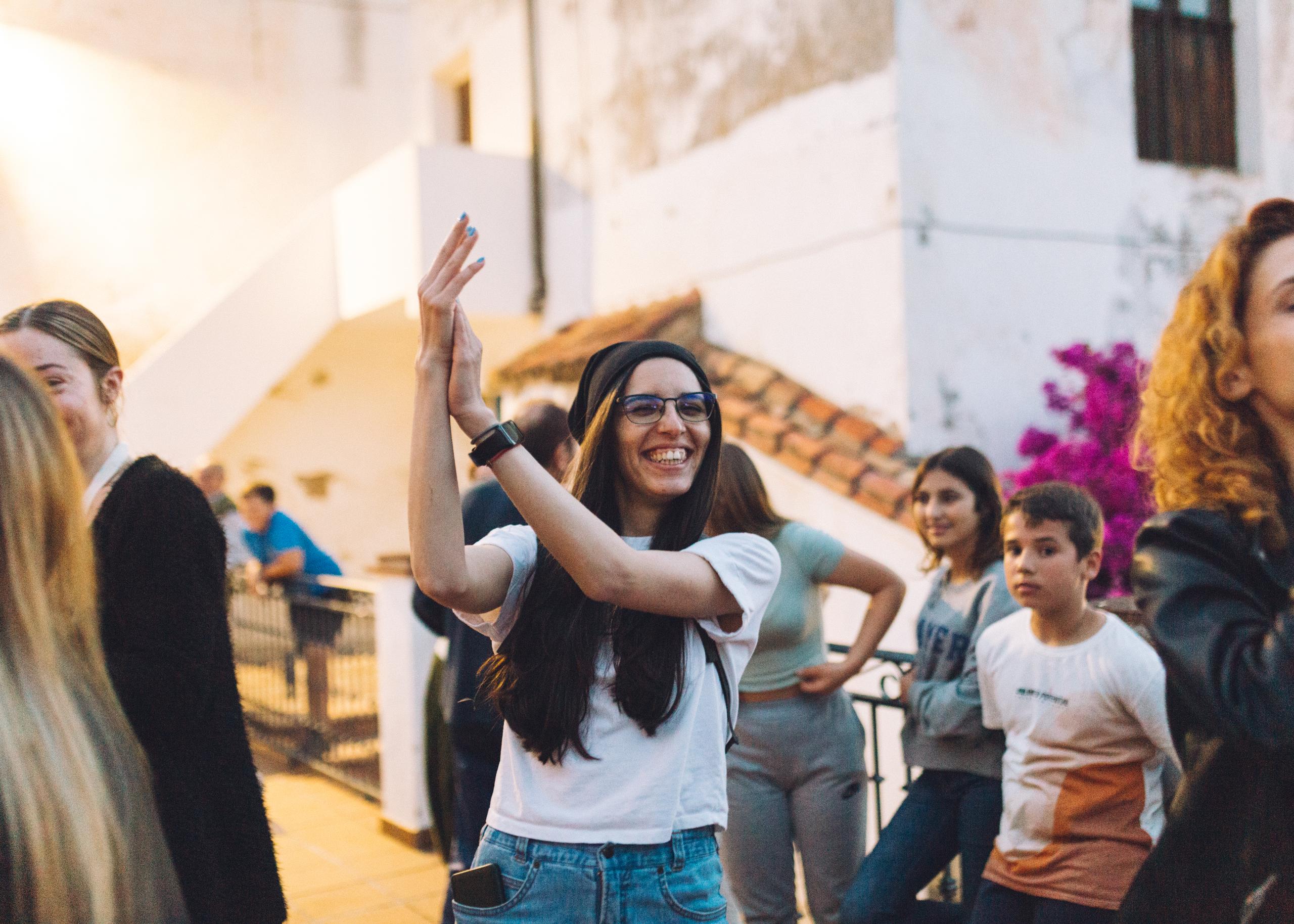 Digital nomad from Northern Europe dancing flamenco with local community in Benarraba Malaga
