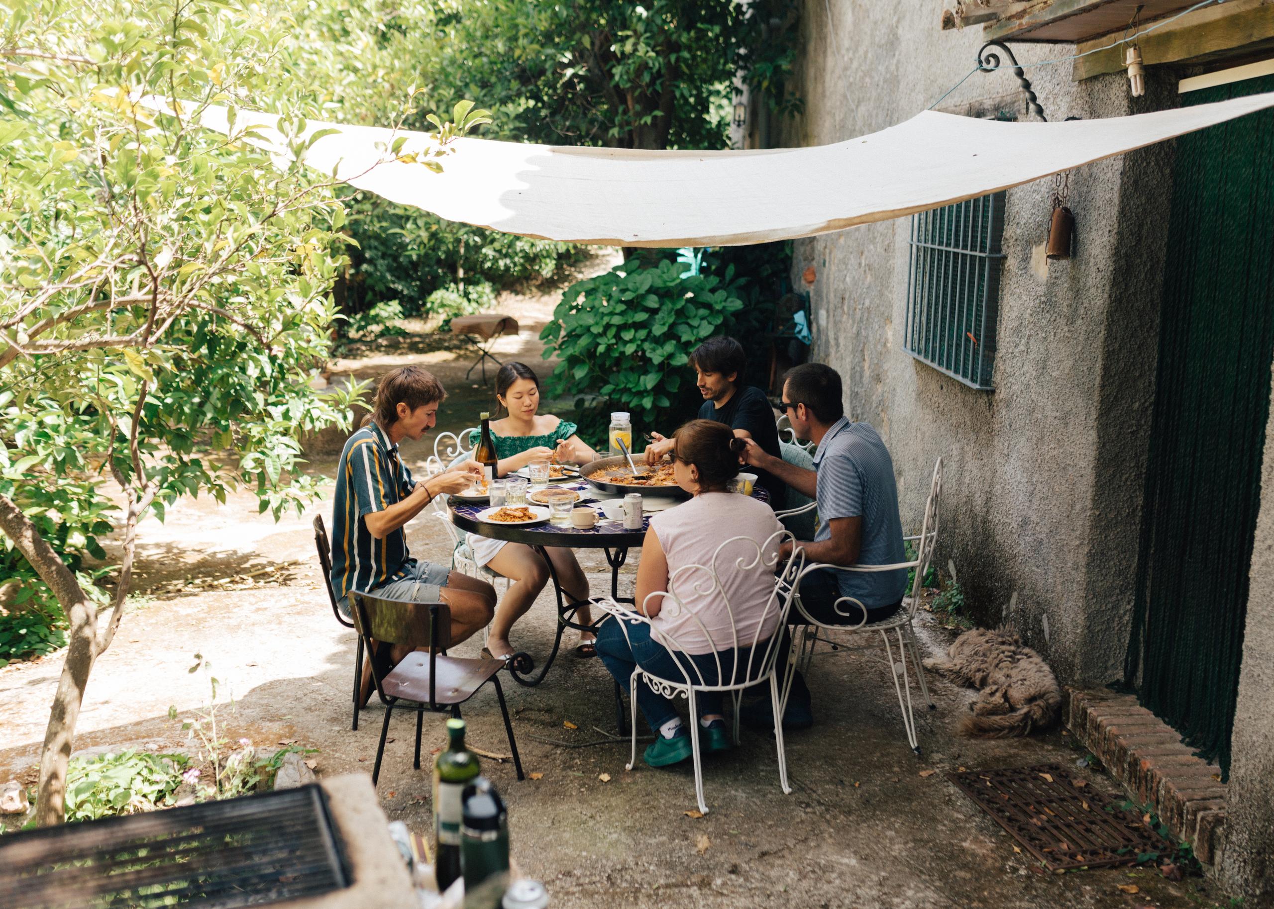 Enjoying a community lunch under the sun on the terrace of our rural coliving space in Benarraba, Andalusia
