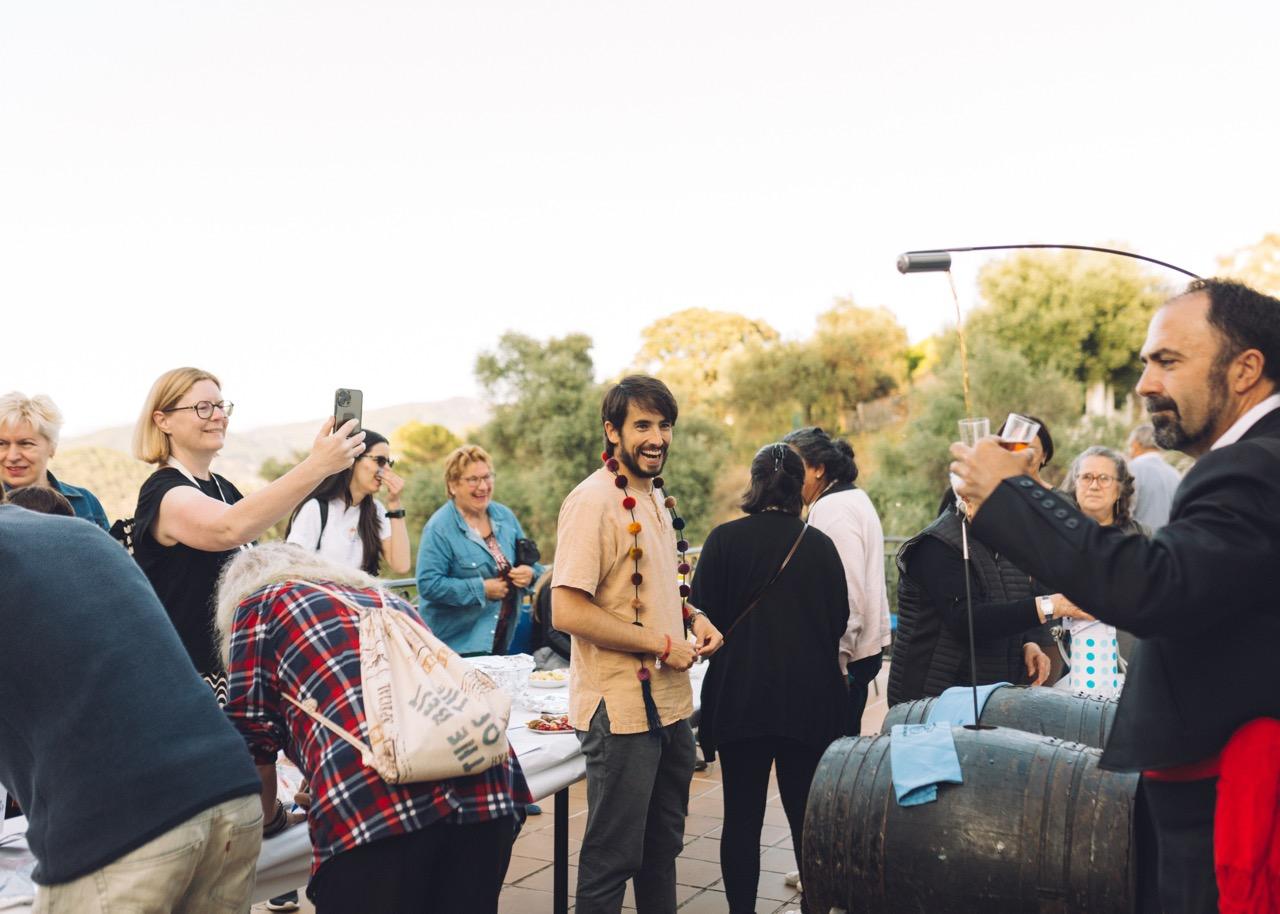 Local party in the village of Benarraba Malaga, with digital nomads and neighbours sharing local wine, Spanish ham and other organic local products