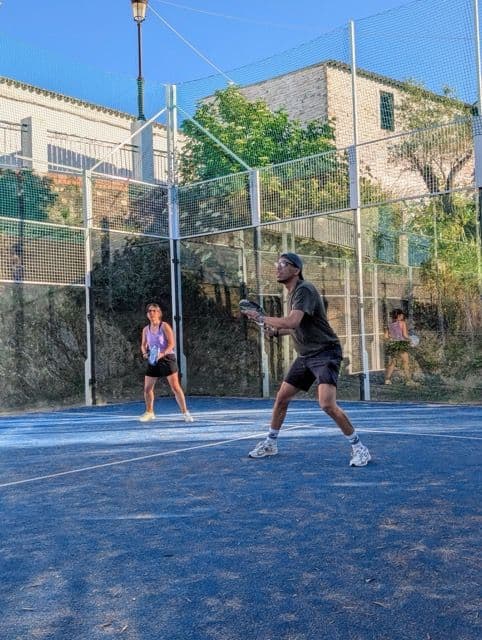 Guests playing a padel match after work in the Malaga rural coliving coworking