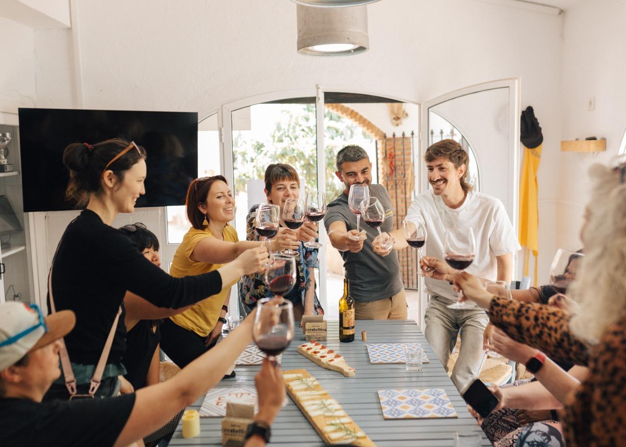 Enjoying local wine while participating in a goat cheese making workshop in Malaga, a memorable activity hosted at Rooral coliving