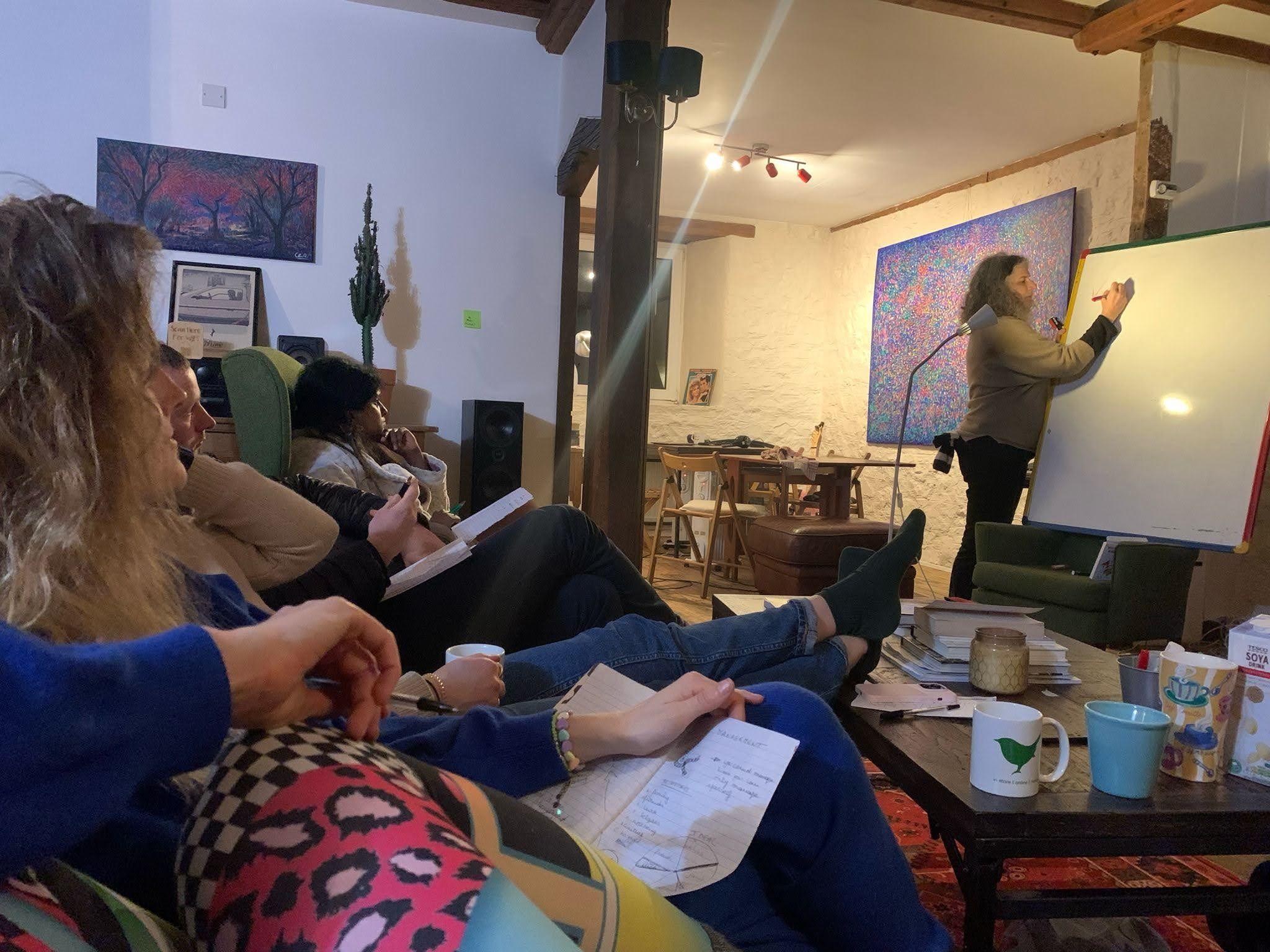 Colivers attending a workshop or presentation in the living lounge area