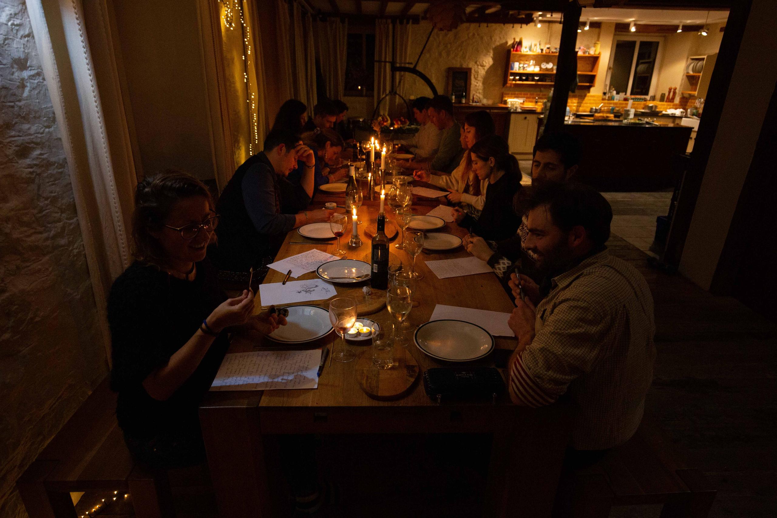 Colivers gathered around the long dining table for a candlelit shared dinner