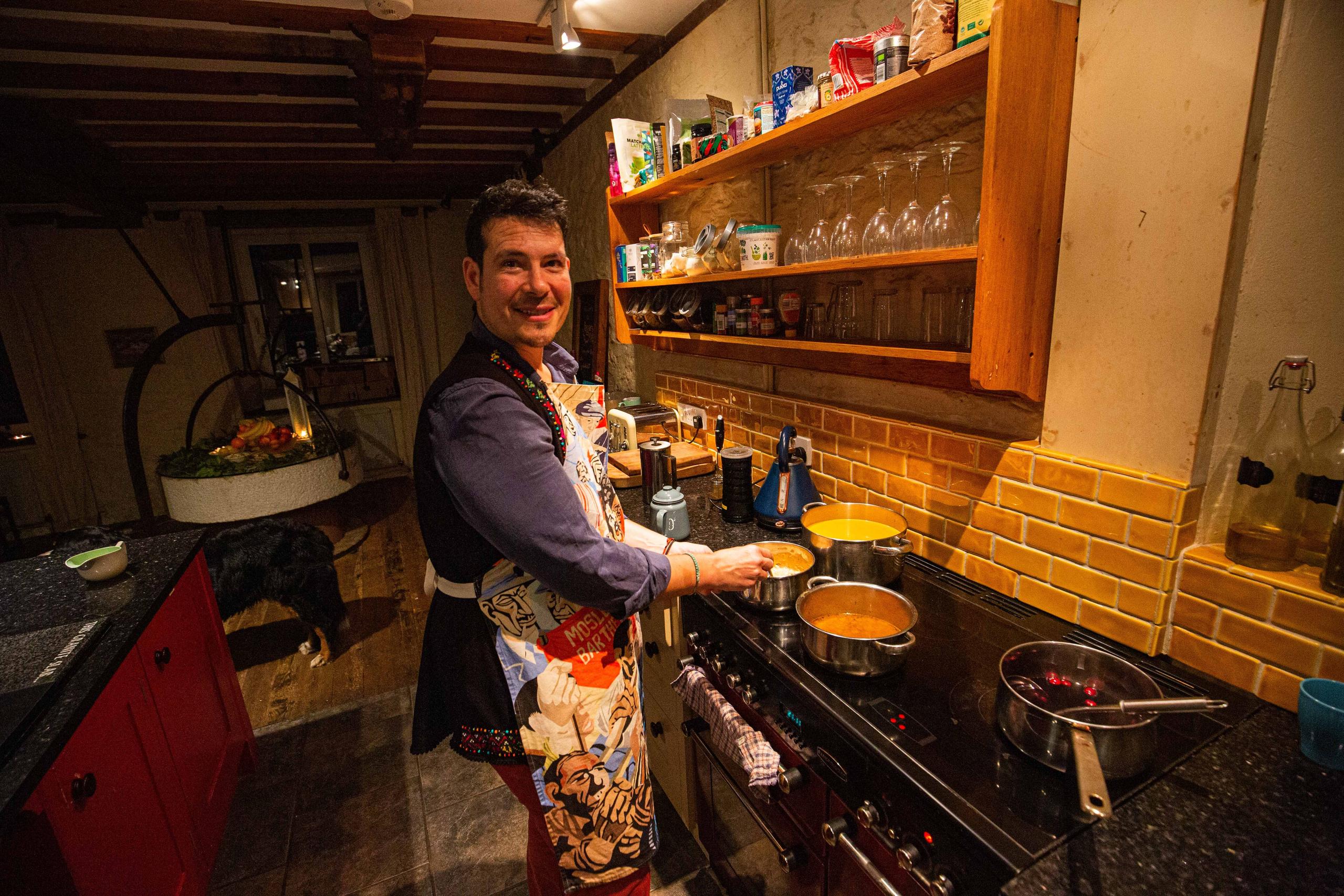 Coliver cooking a meal in the shared kitchen