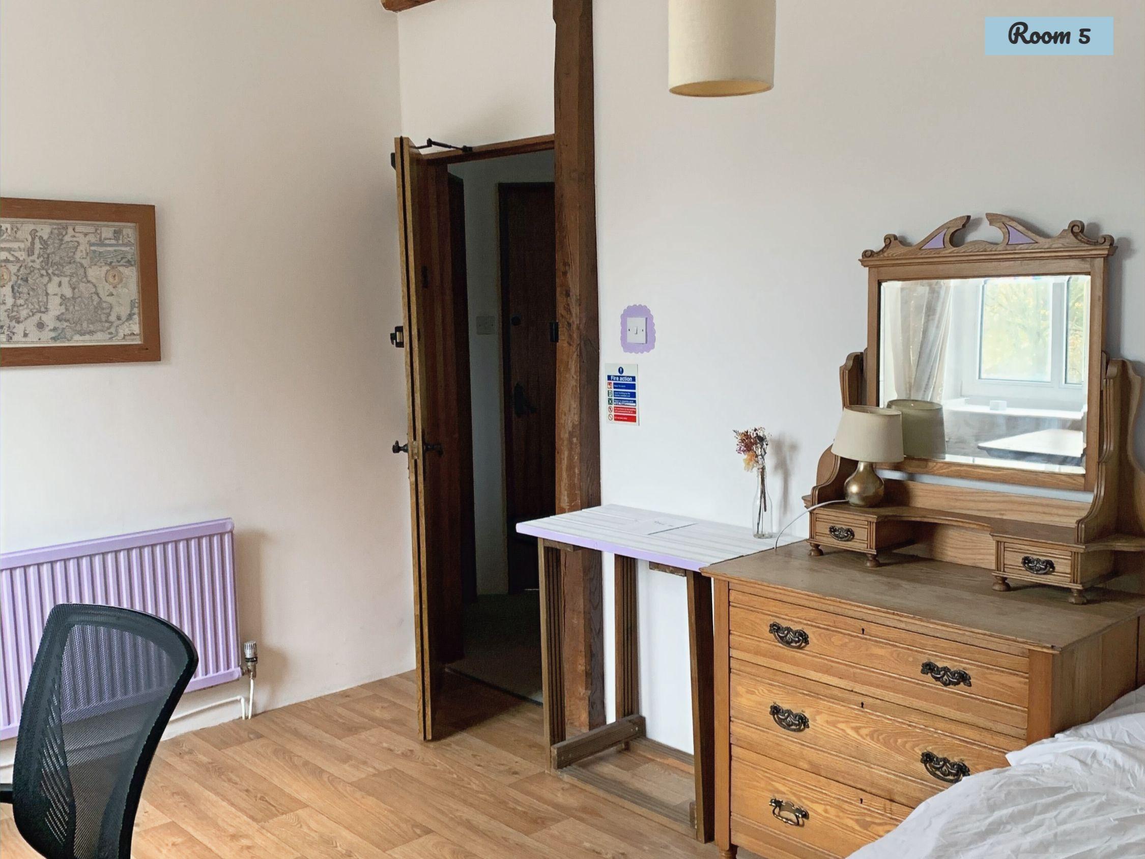 Private double room with wooden dresser, desk and chair in the Mill House