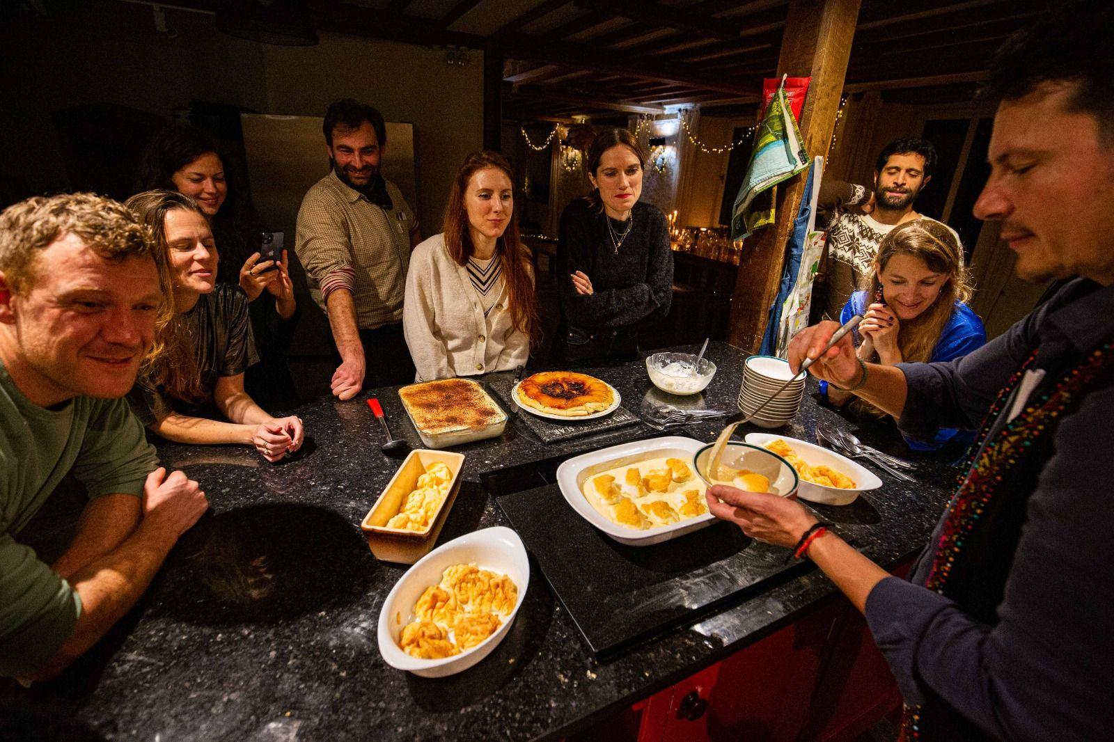 Colivers gathered around the long dining table for a shared dinner with candles
