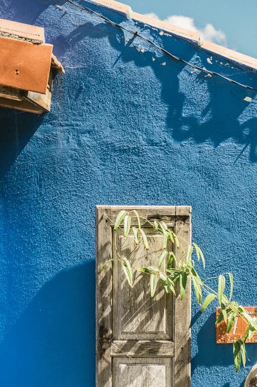 picture of a blue house, with old wooden doors