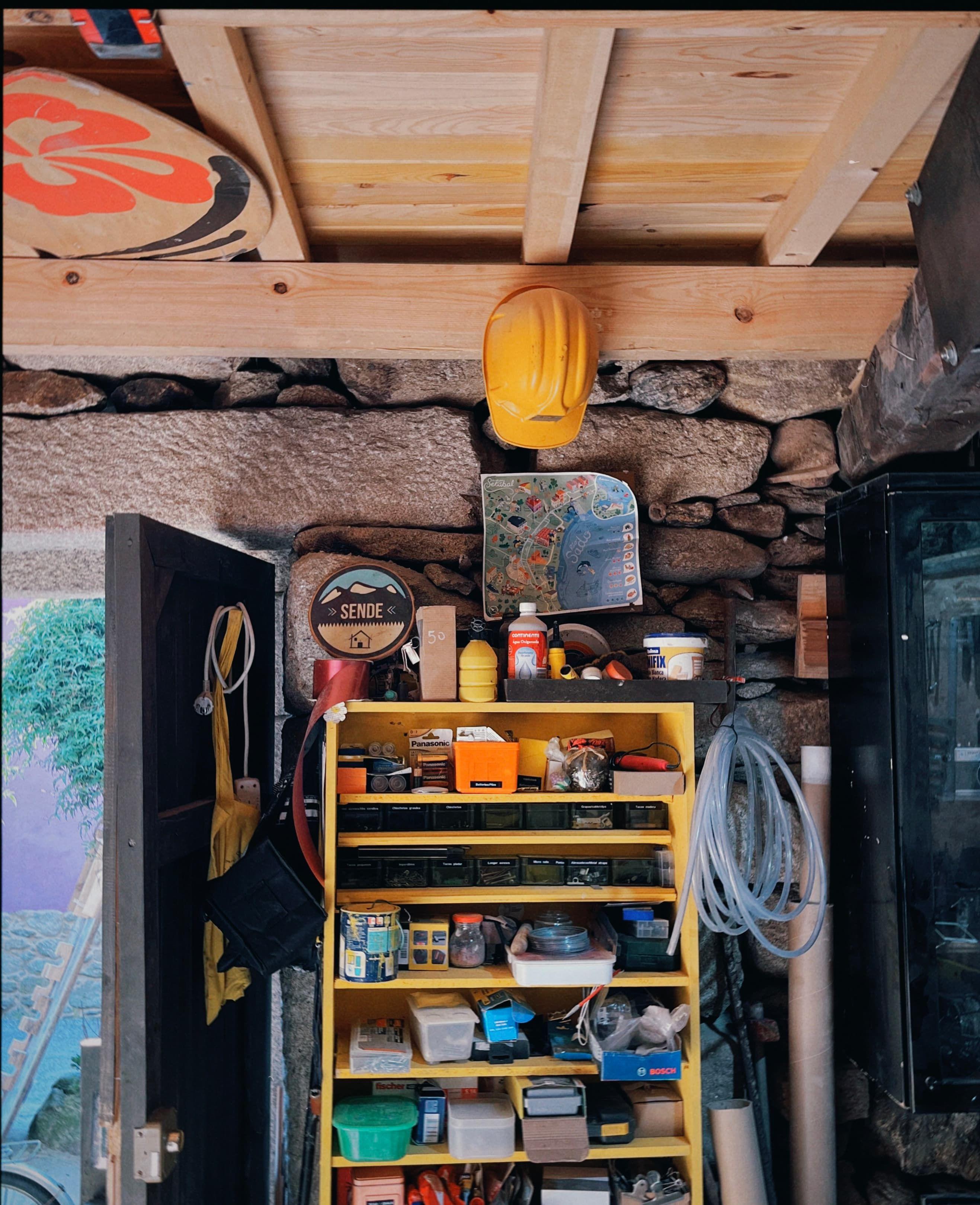 Interior of the Sende tool workshop showing organized shelves with supplies, tools, and a yellow hard hat