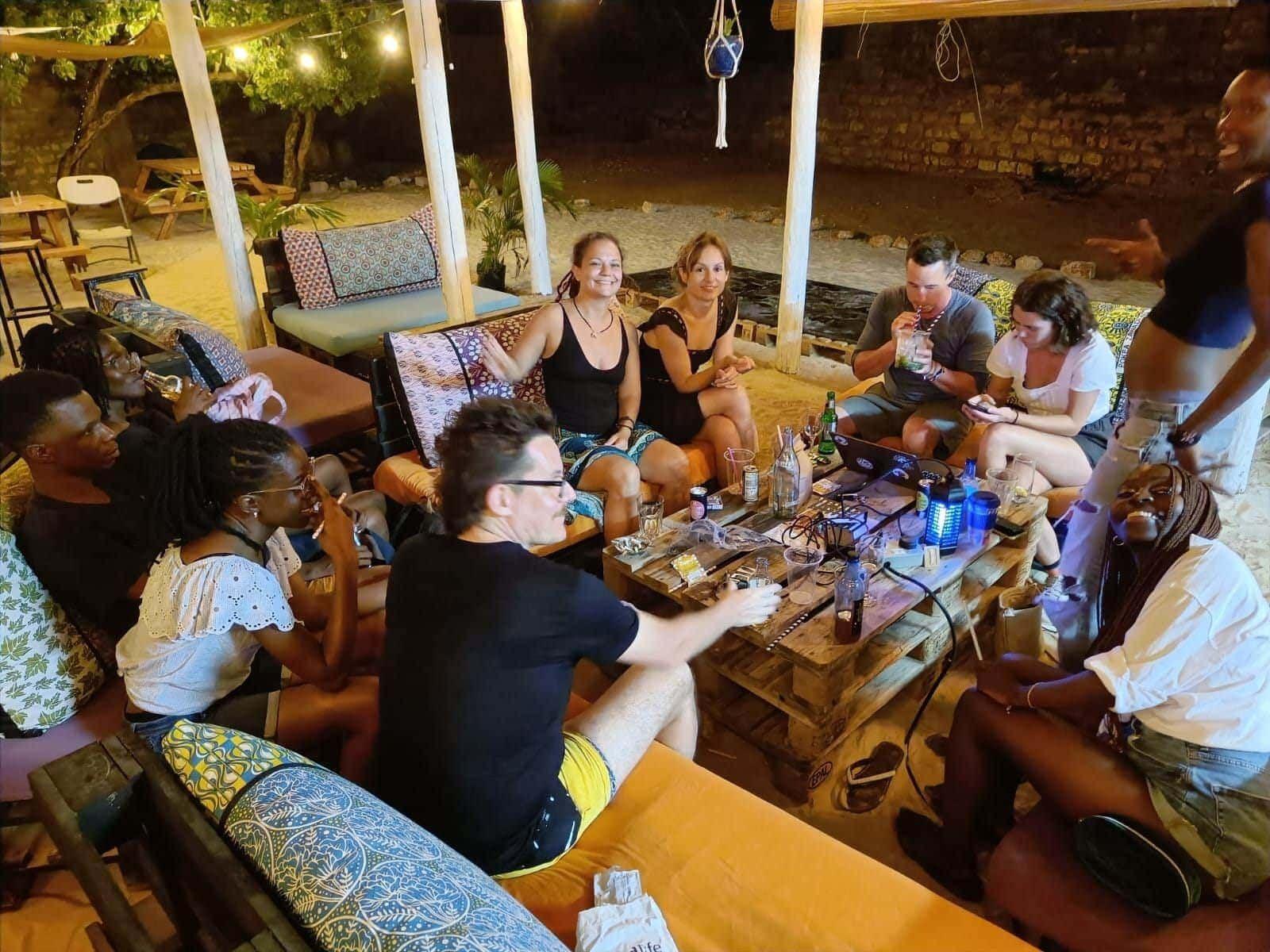 Group of guests socialising at the outdoor lounge area in the evening