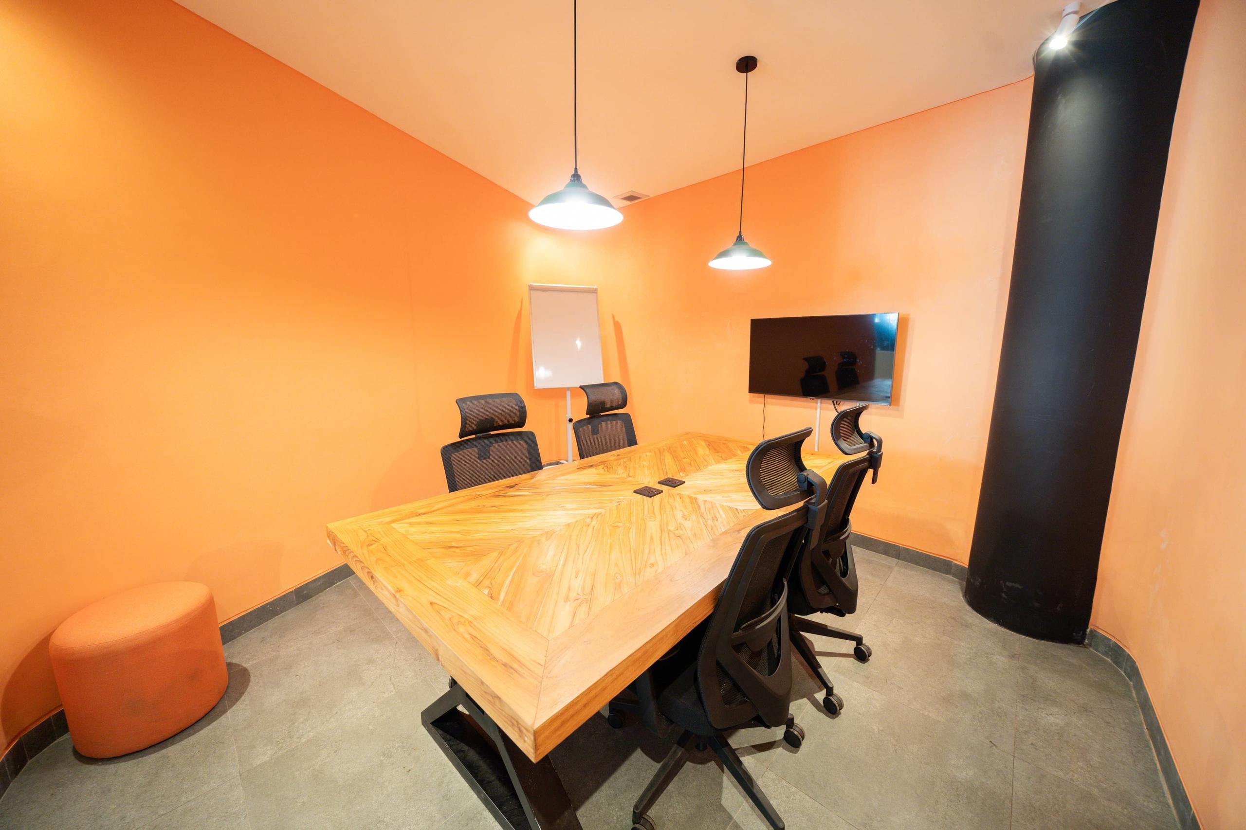 Air-conditioned small meeting room comfortably seating 4–6 people