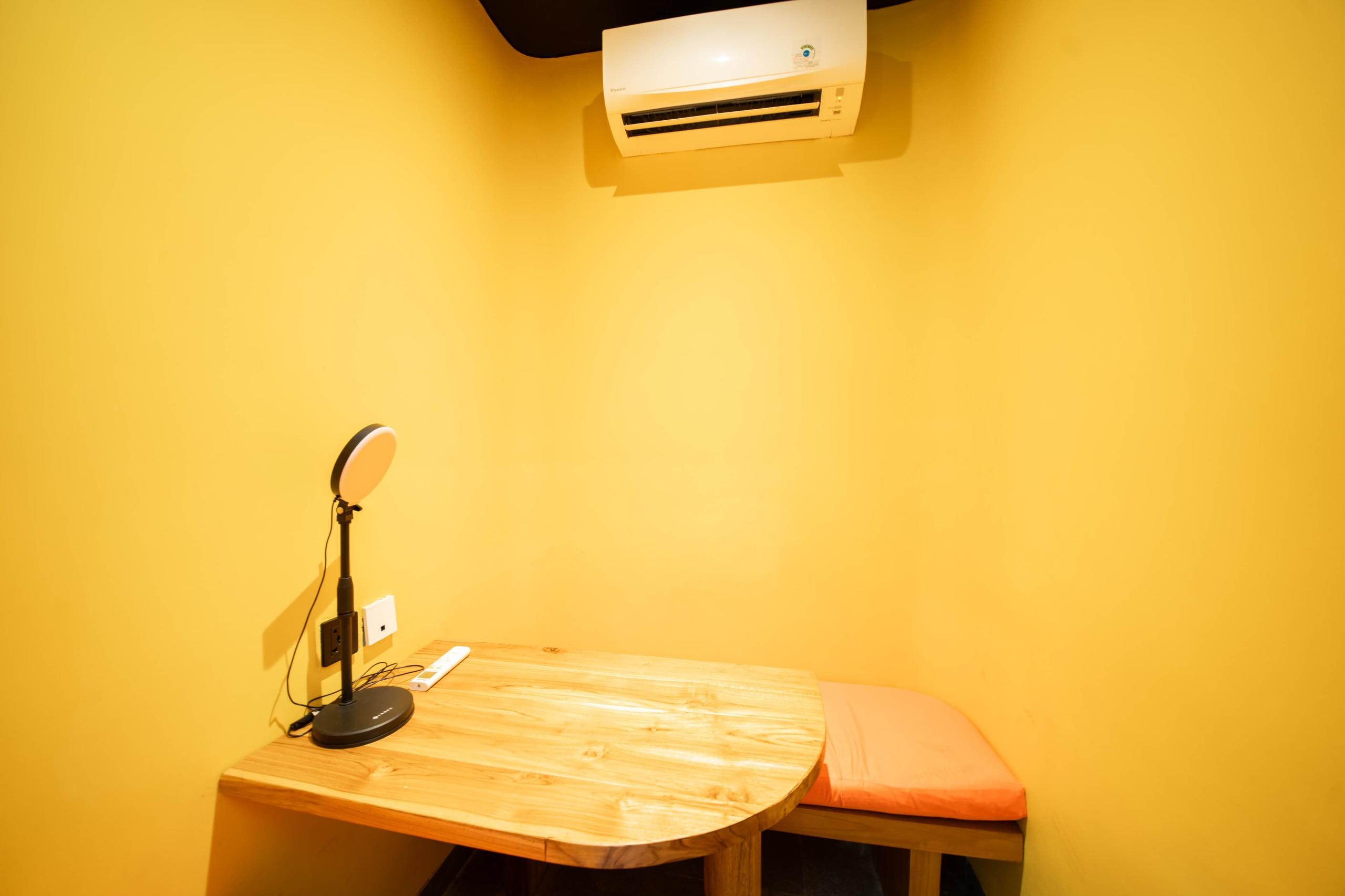 Small private focus room optimized for quick calls and focused work with upright seating