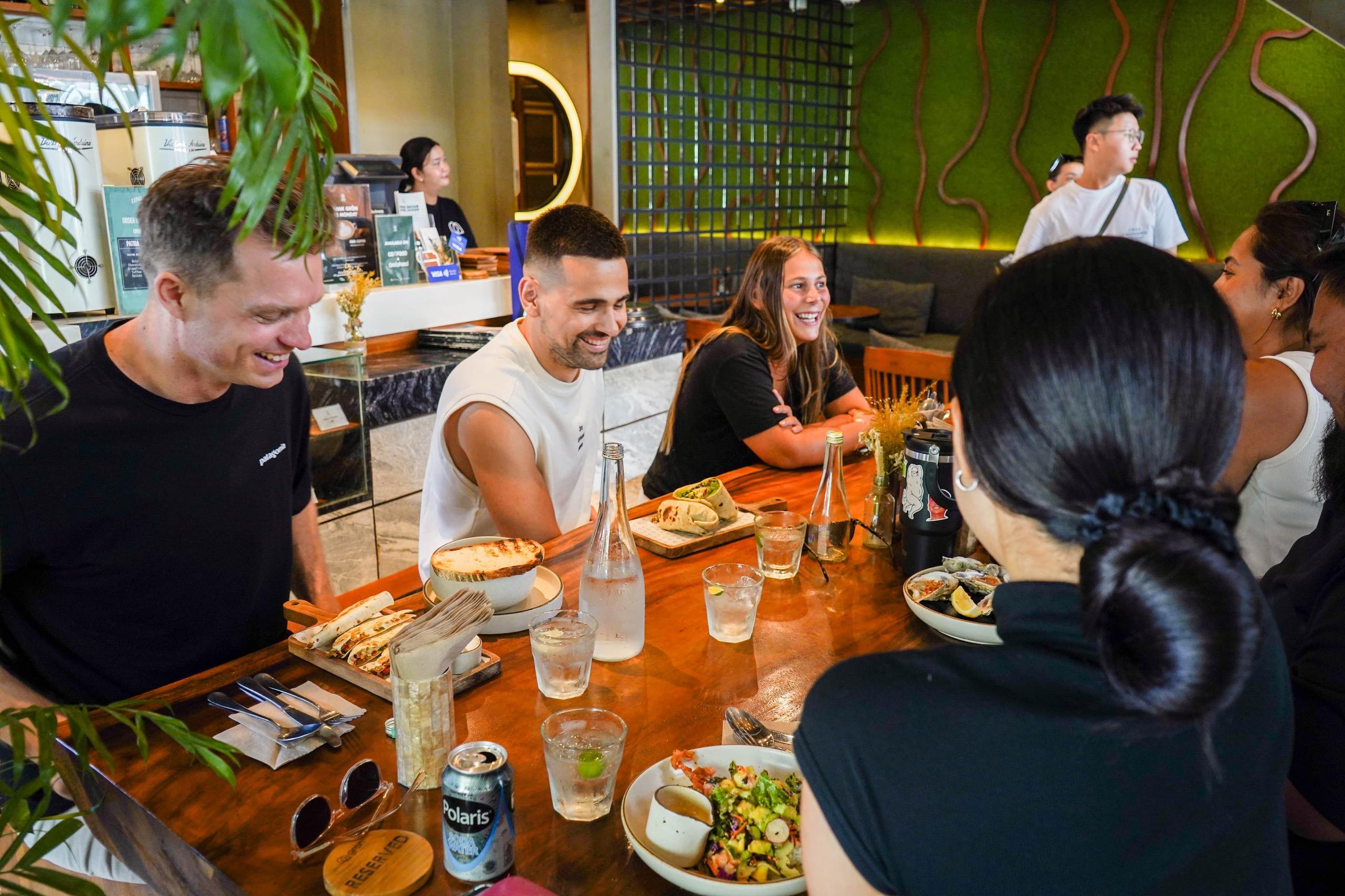 Group of residents laughing and dining together at a restaurant table
