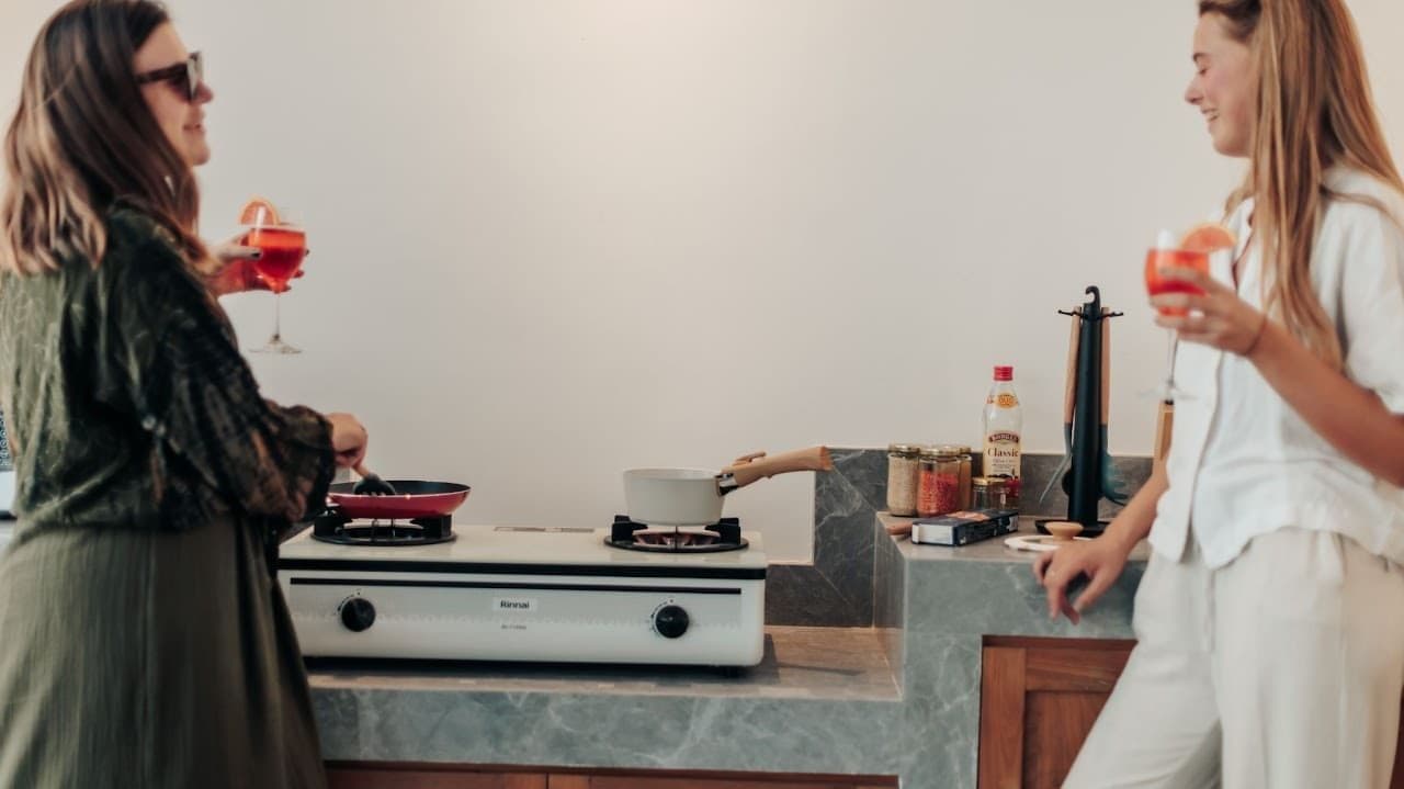 Fully equipped shared kitchen with coffee station, blenders, fridges, and spacious dining area