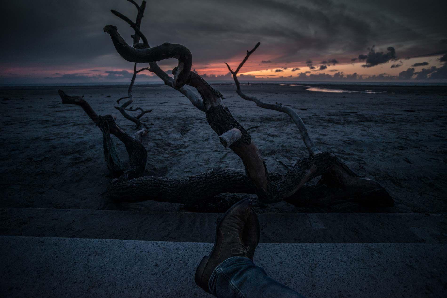 Driftwood on Blackpool beach at sunset with dramatic sky