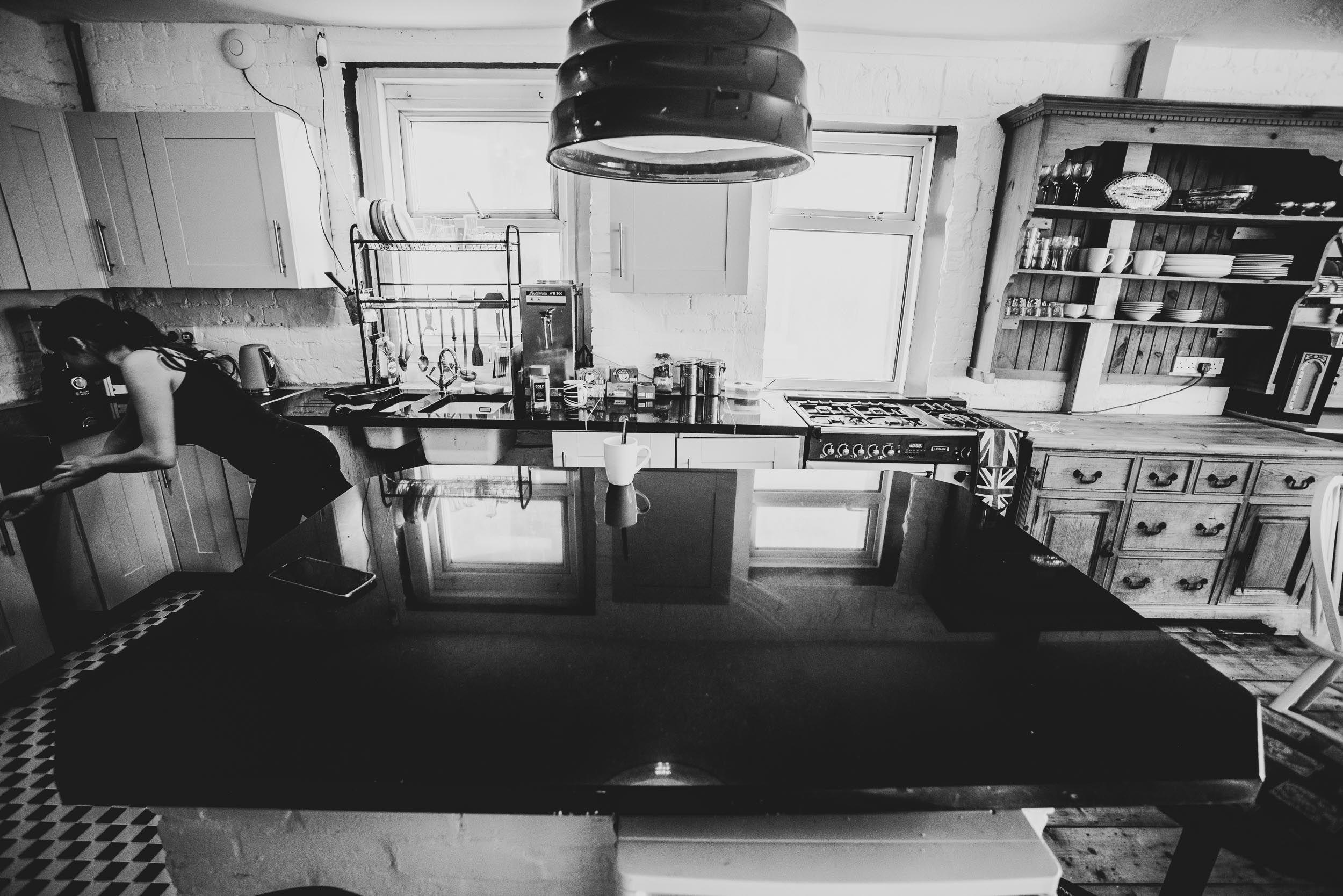 The kitchen with large granite island, gas cooker, and wooden dresser