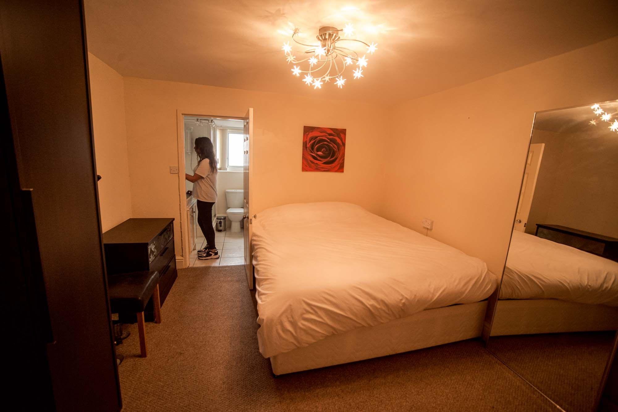 Large double bedroom with ensuite bathroom visible through the door