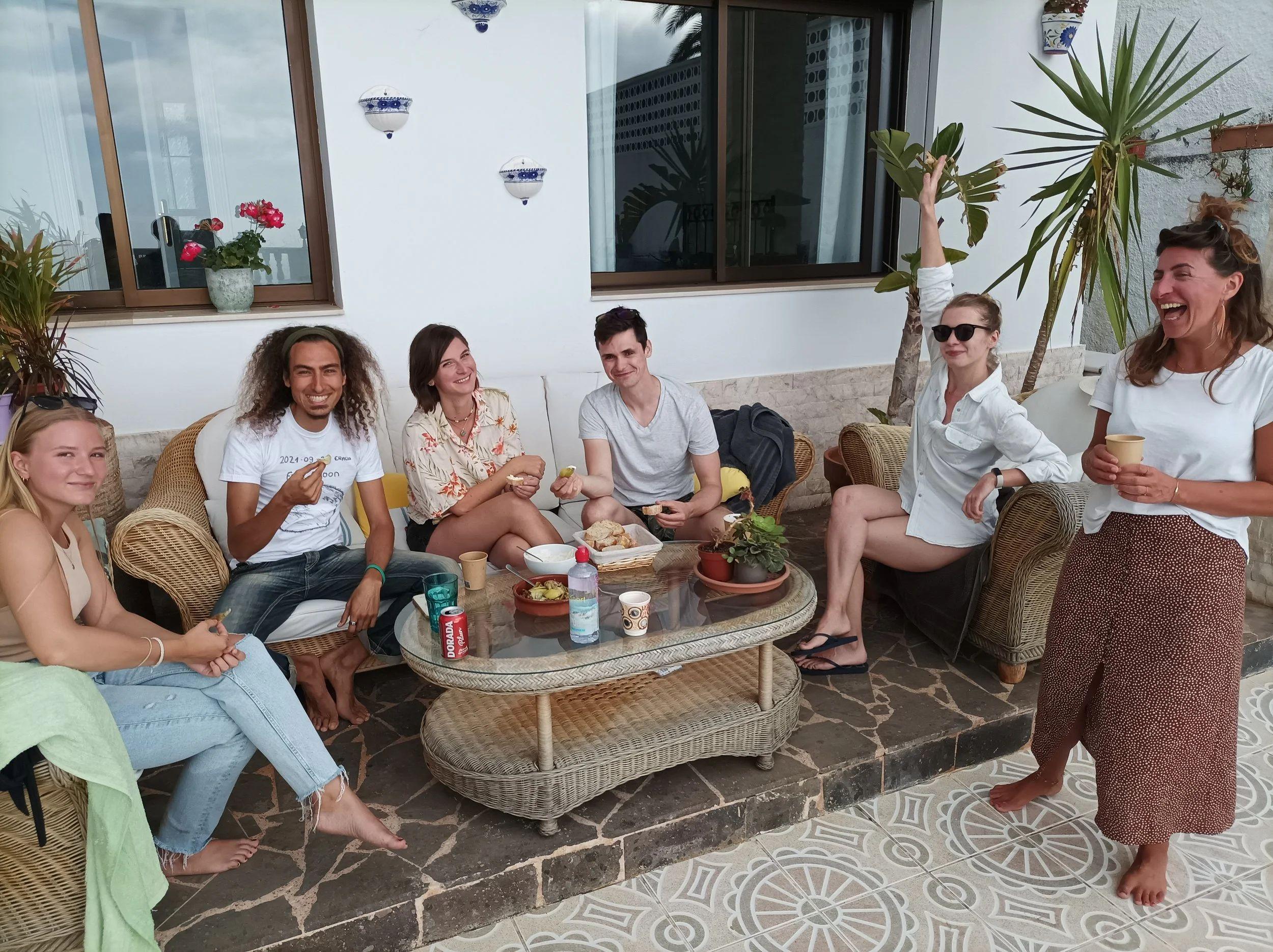 Group of guests relaxing and socializing on the outdoor porche lounge area