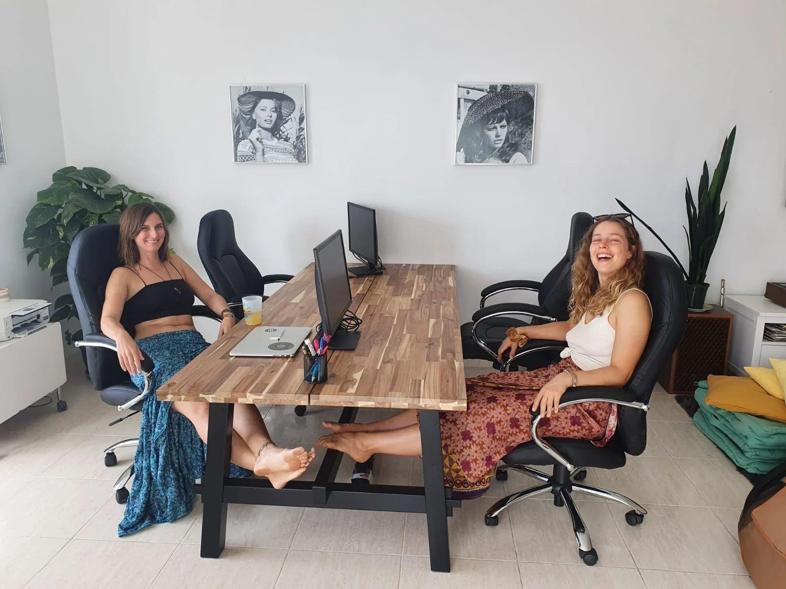 Shared workspace in the main hall. Monitors and ergonomic chairs available.
