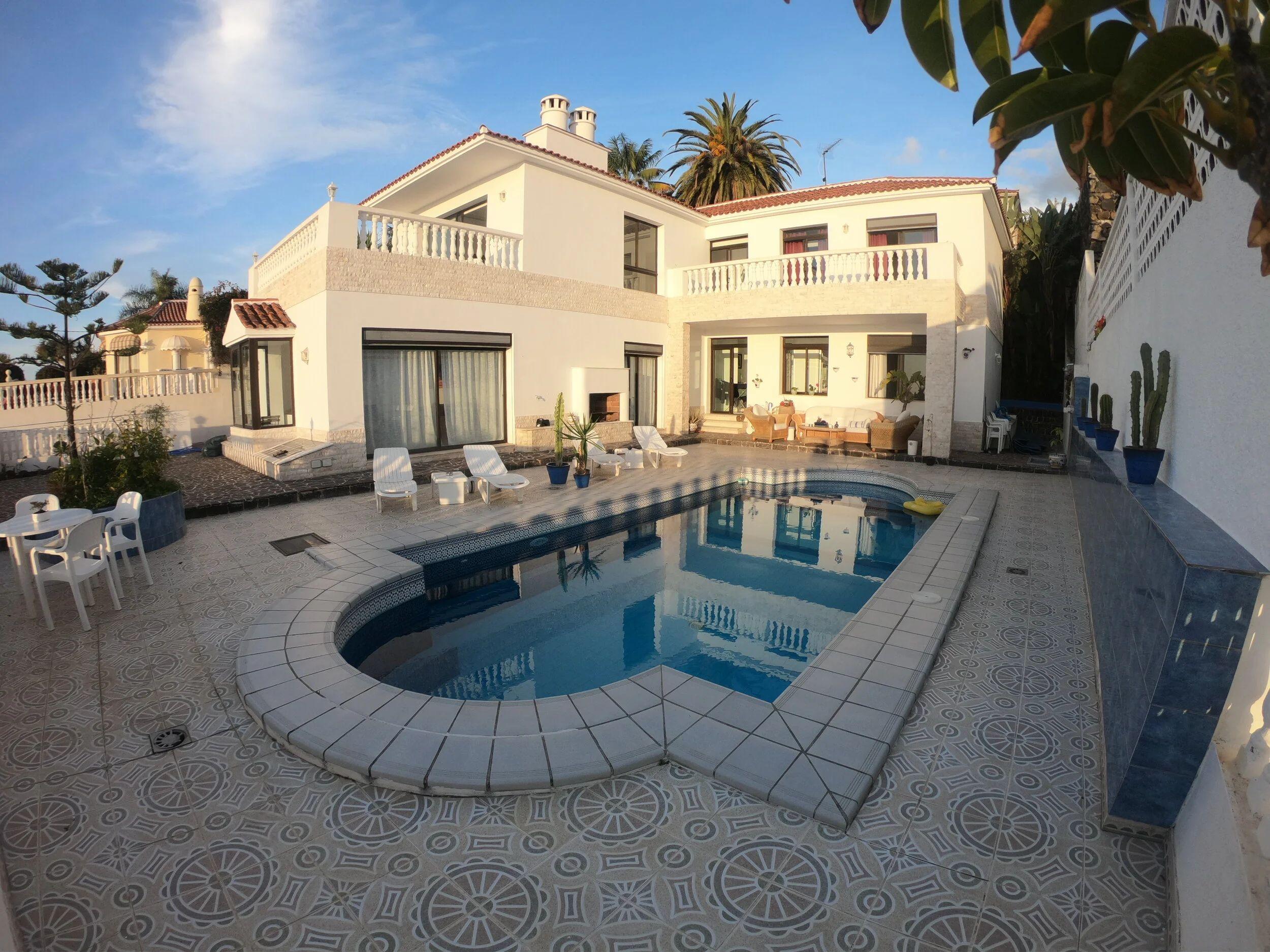 Full exterior view of the Taoro Coliving villa with pool in the foreground