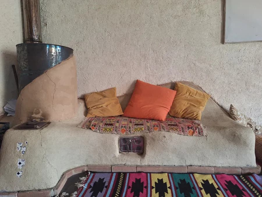 The clay rocket stove (mass heater) in the barn at Tertulia coliving