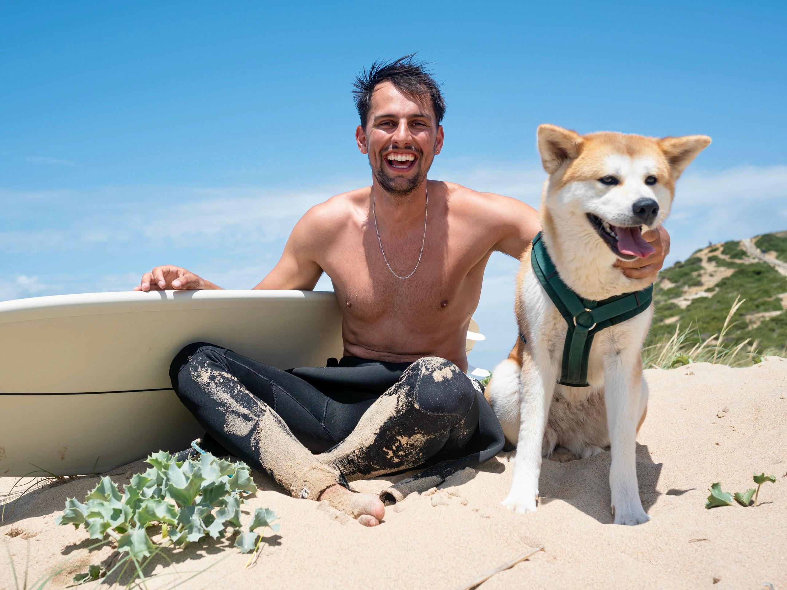 Person surfing with a dog at the beach near Ericeira